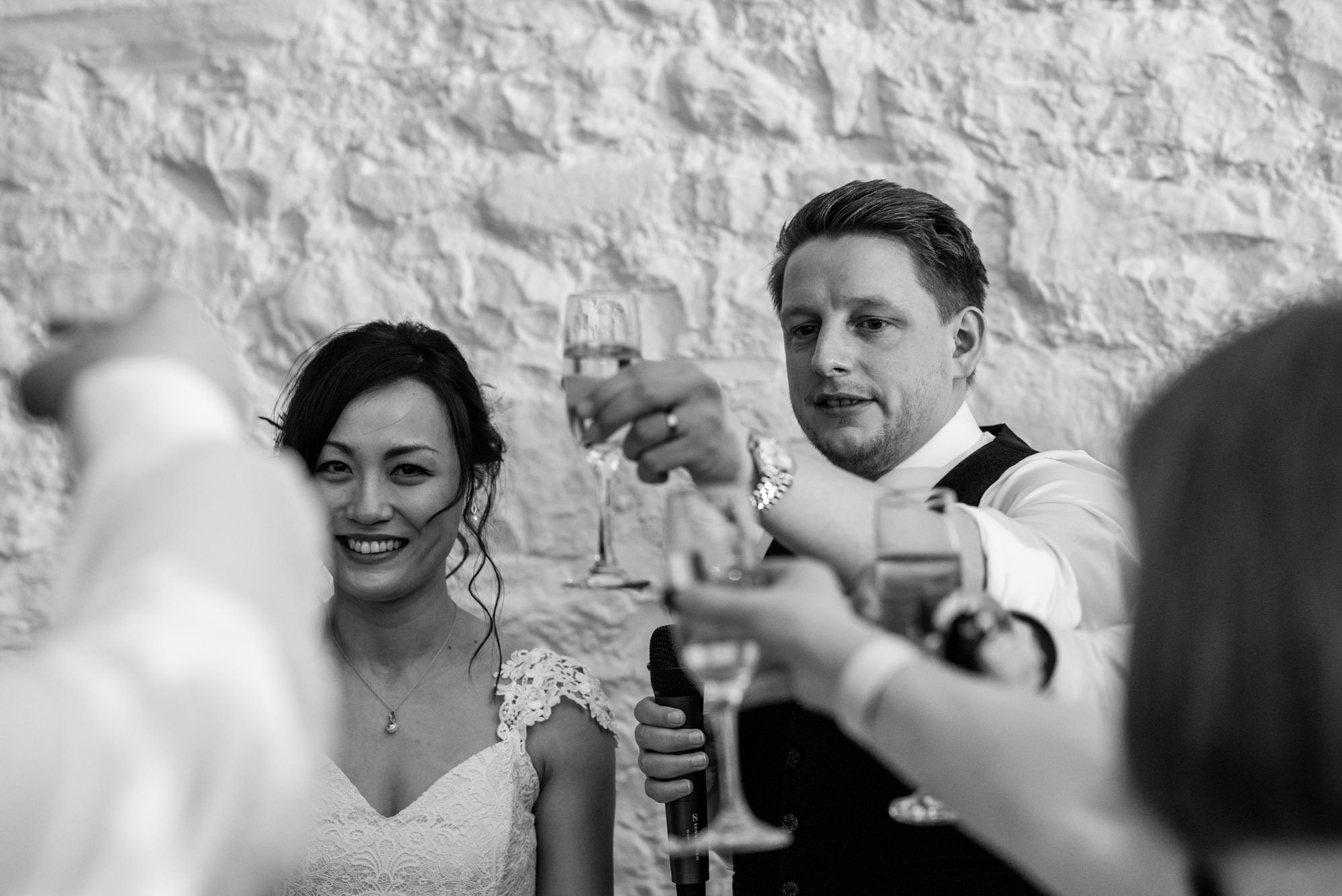 The bride and groom share a toast during the wedding speeches.