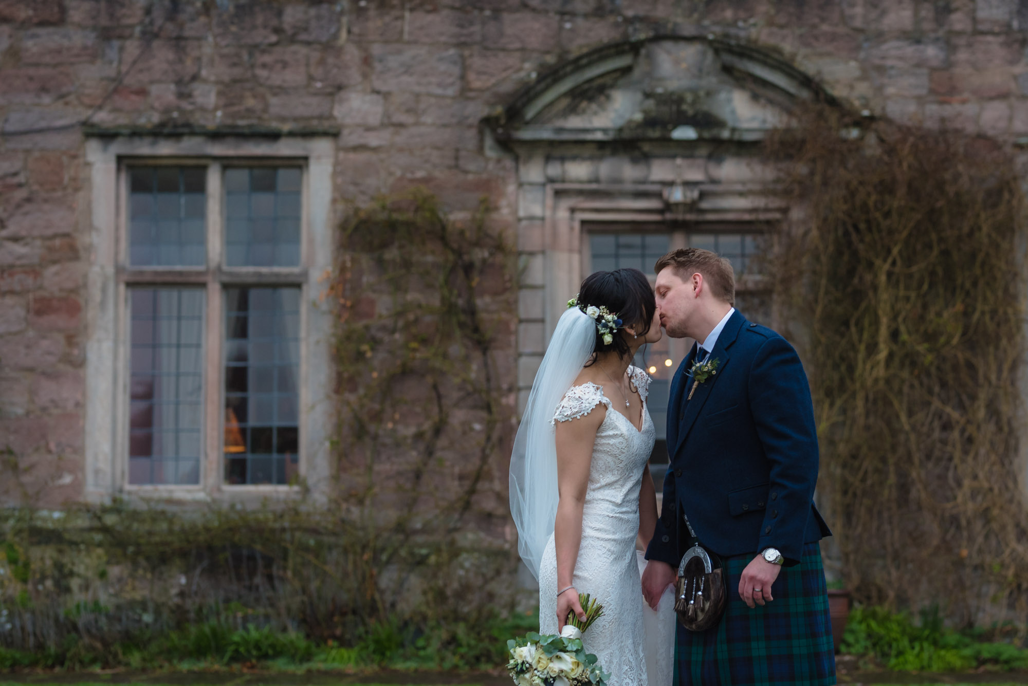 Bride and groom stand for a kiss during their Shropshire wedding photography.