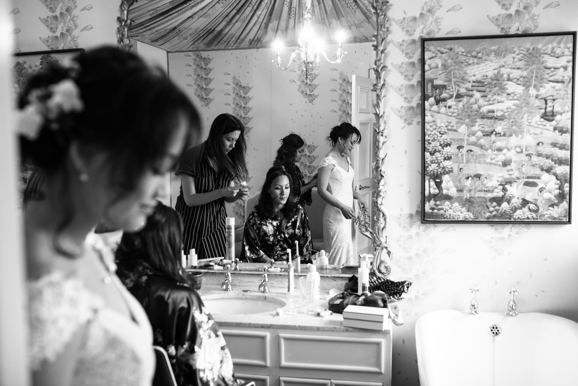 The brides reflection is seen in the mirror as she gets ready for her wedding ceremony.