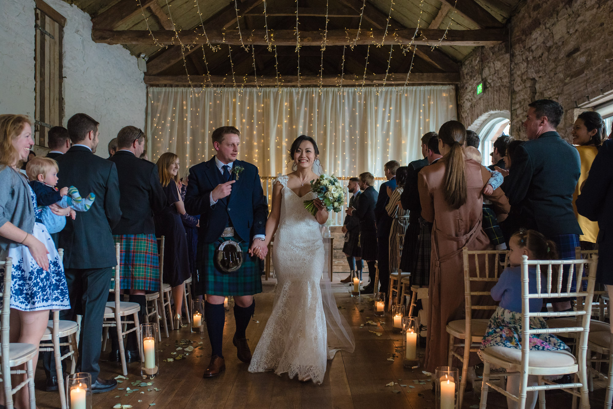 The bride and groom make their exit after their wedding ceremony.