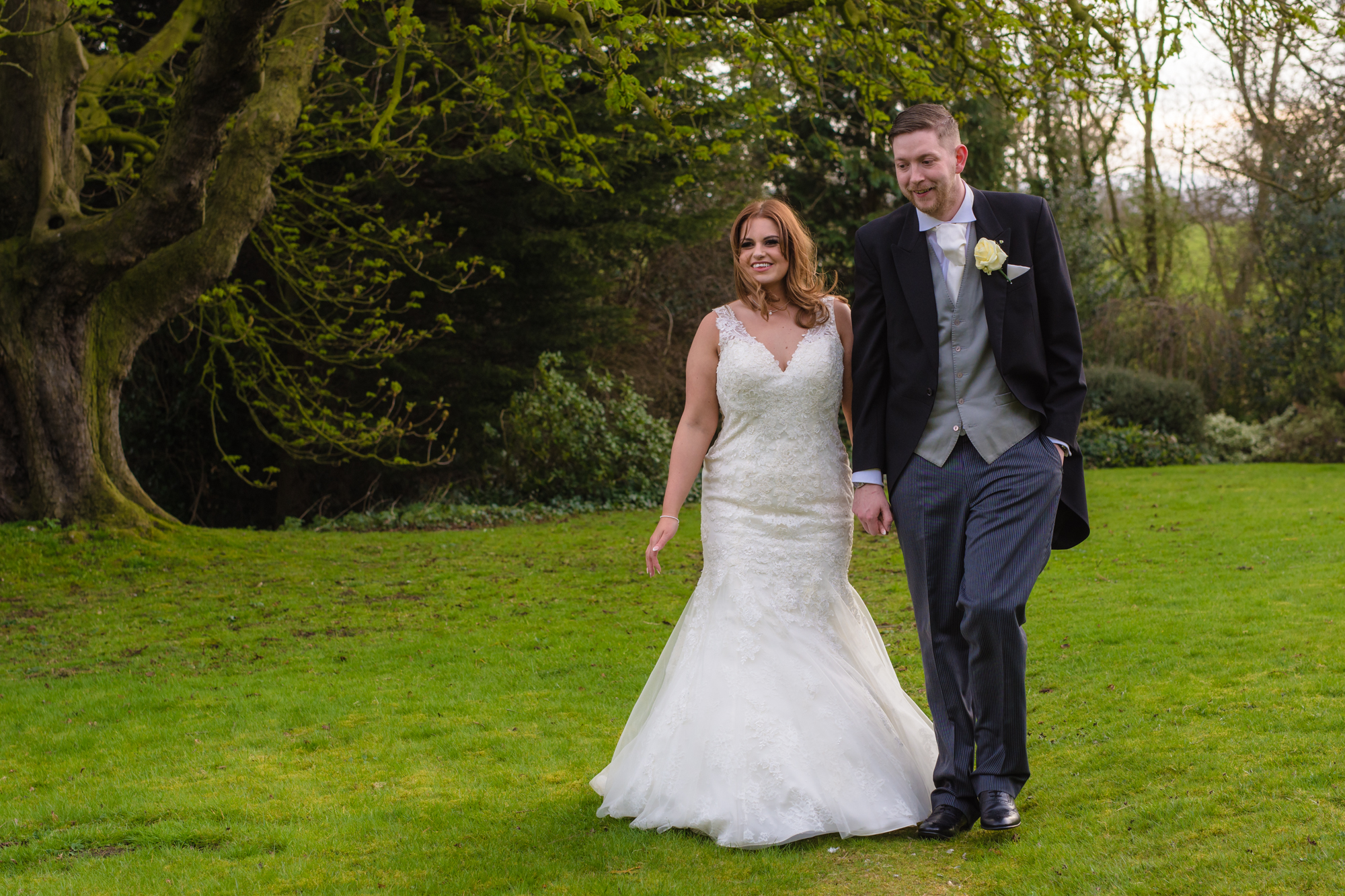 The bride and groom walk towards the camera.