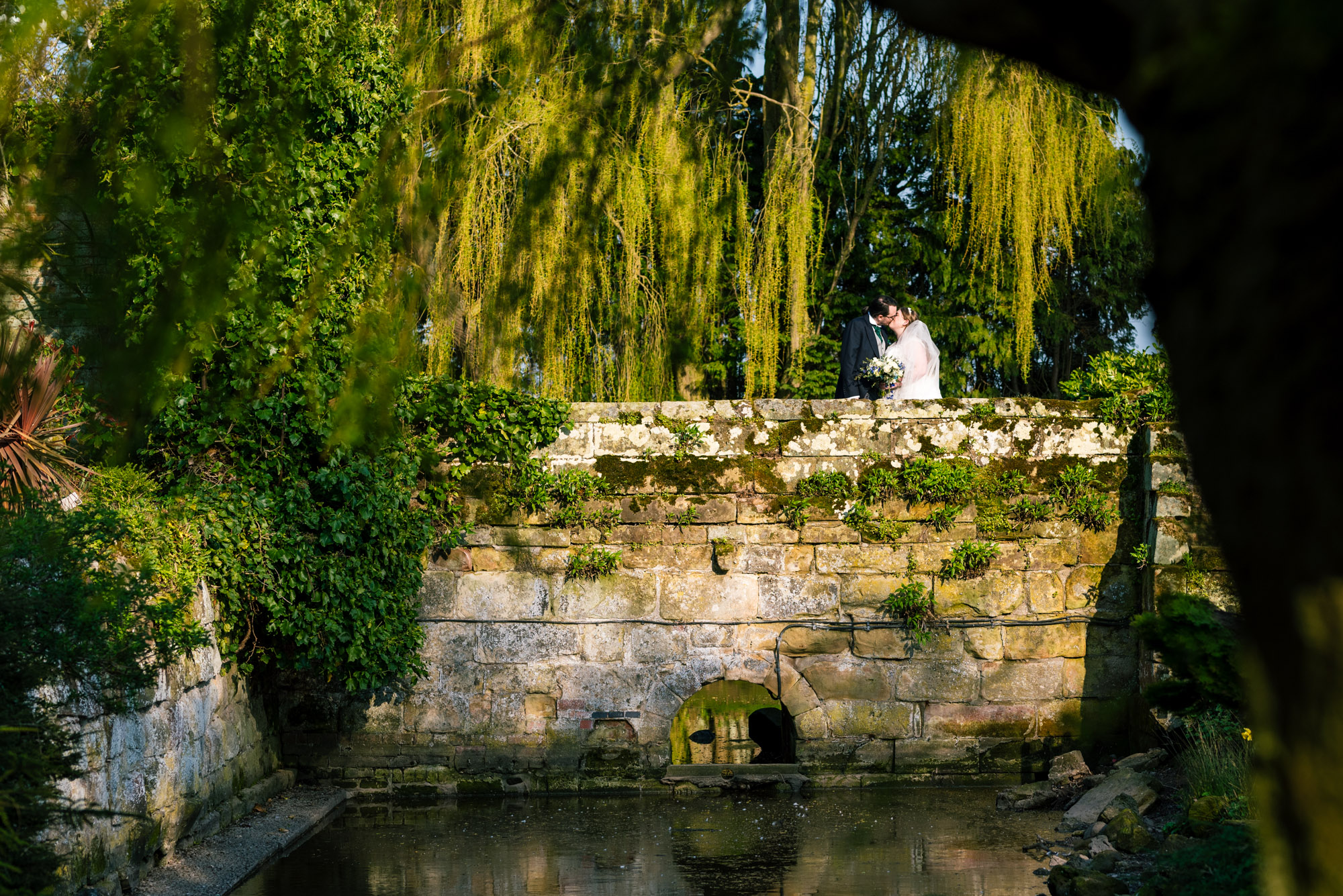 Bride and groom portraits on the bridge over the old moat