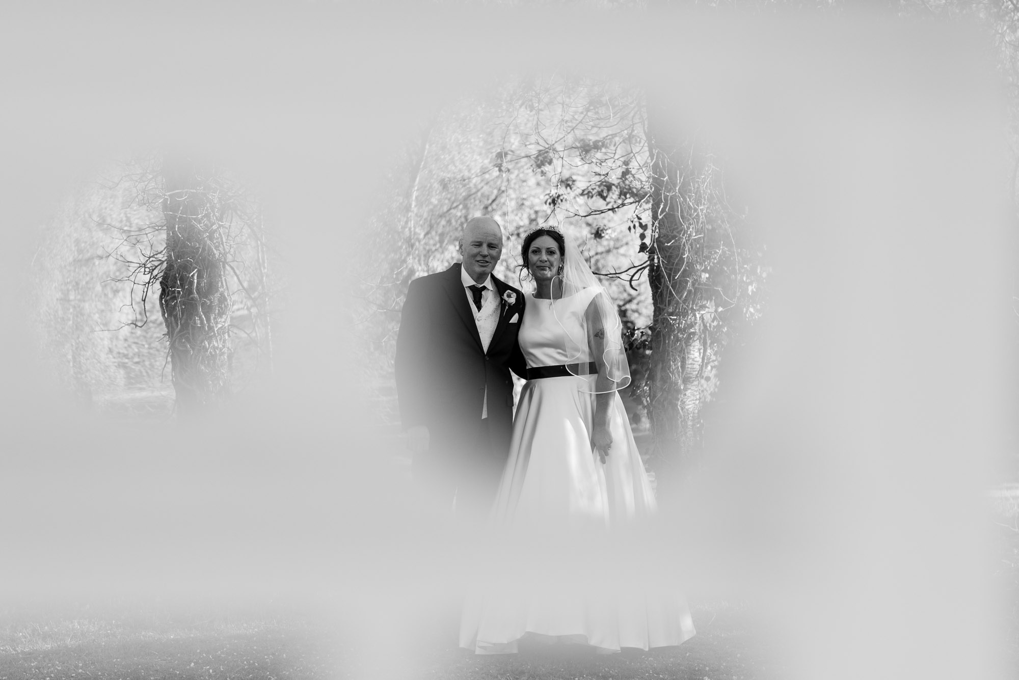 Bride and groom - taken through some railings