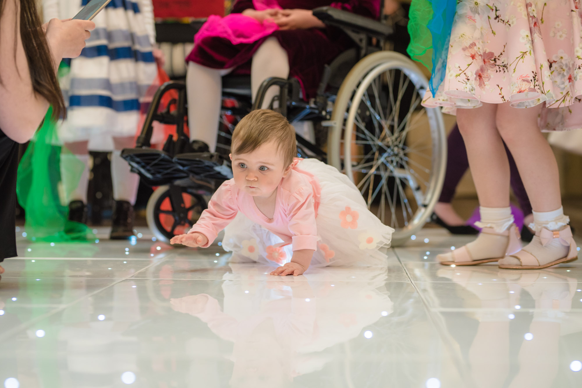 Baby looking for lights on the dance floor