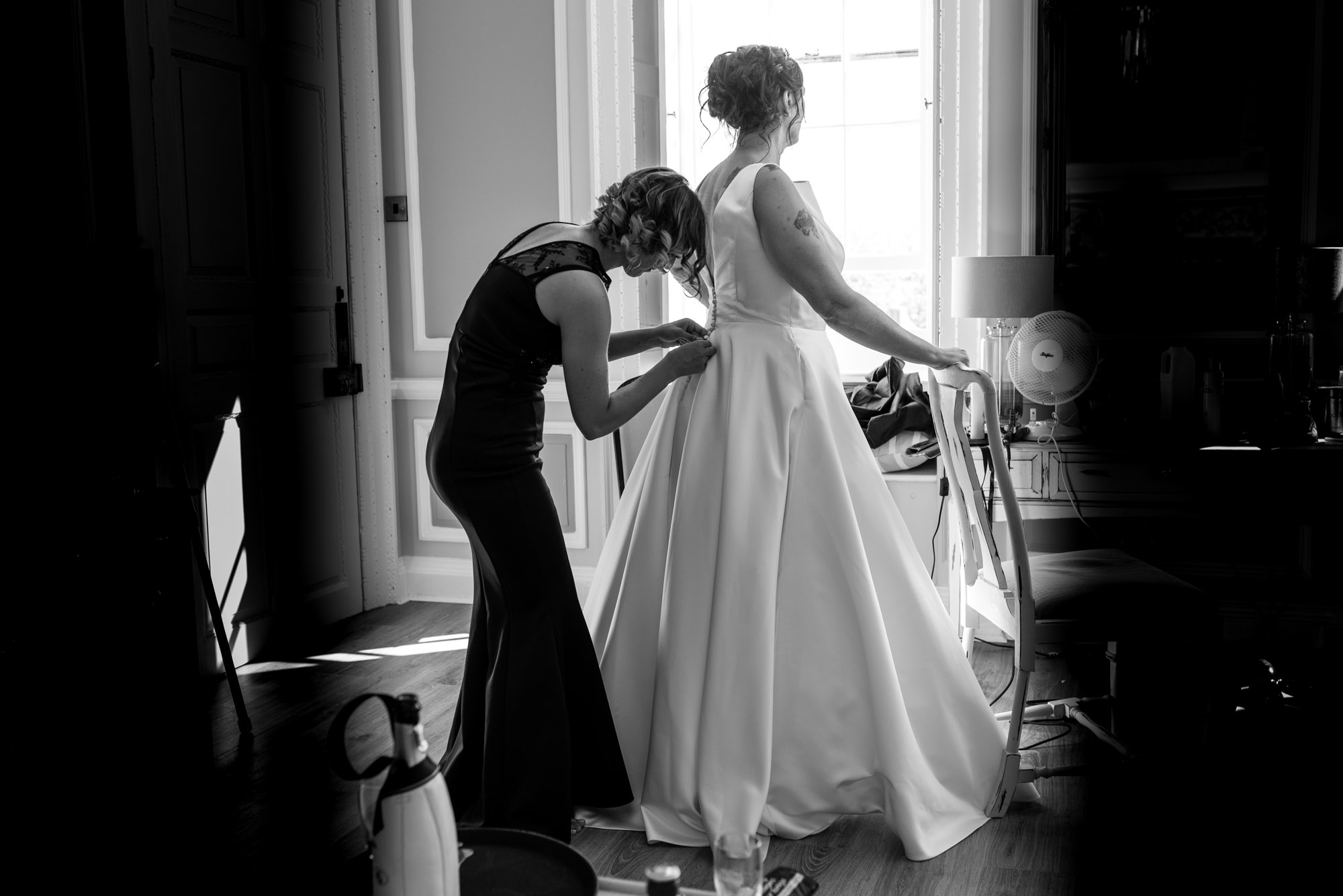 Bride is zipped into her dress