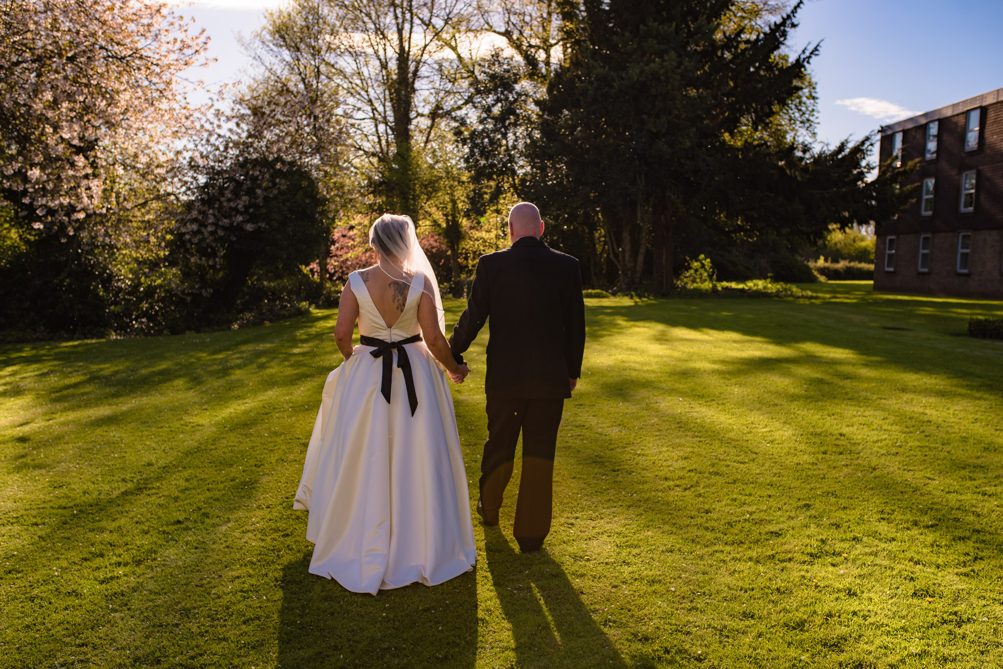 The Bride and groom walking in the grounds