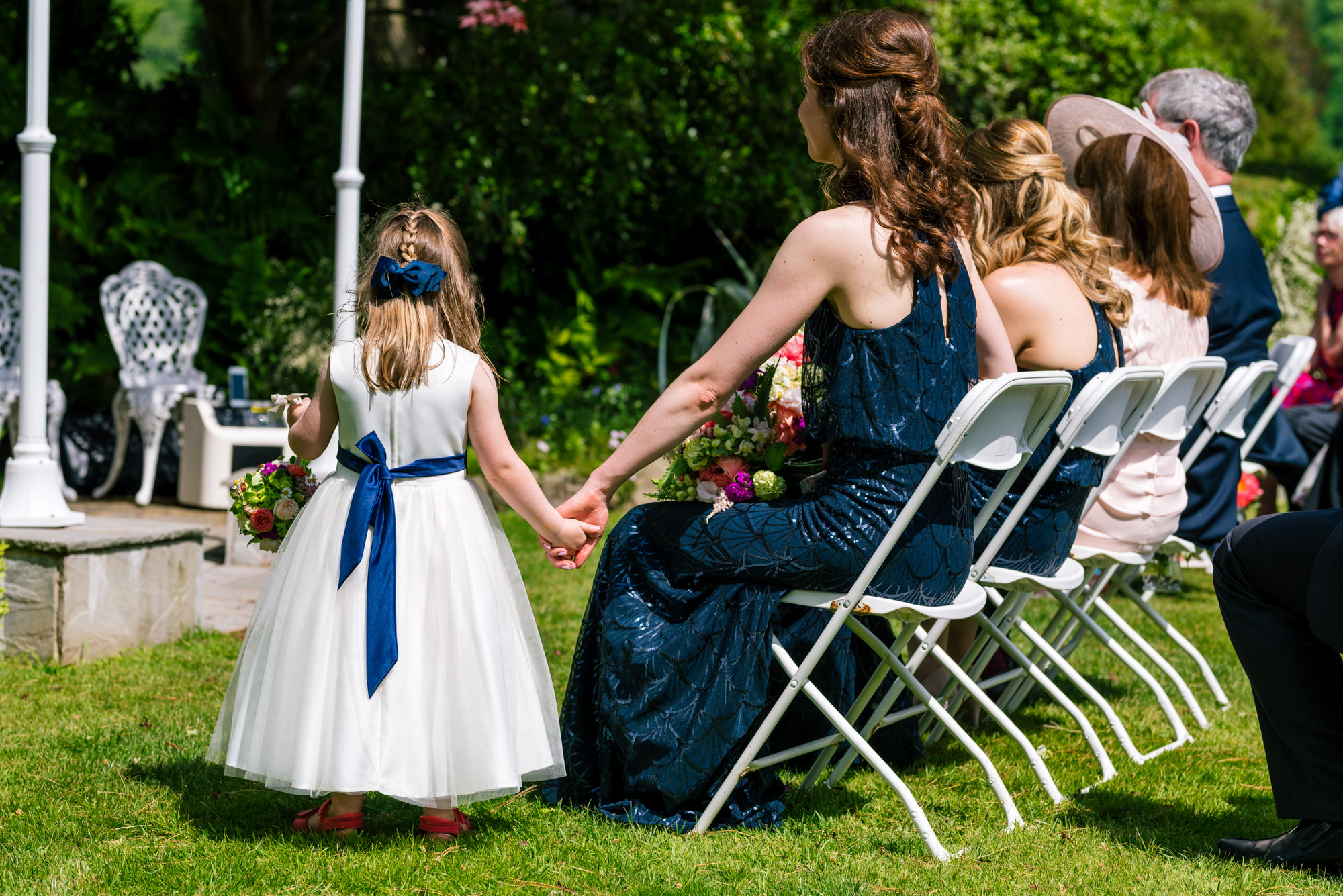 Bridesmaids and flower girl watch on