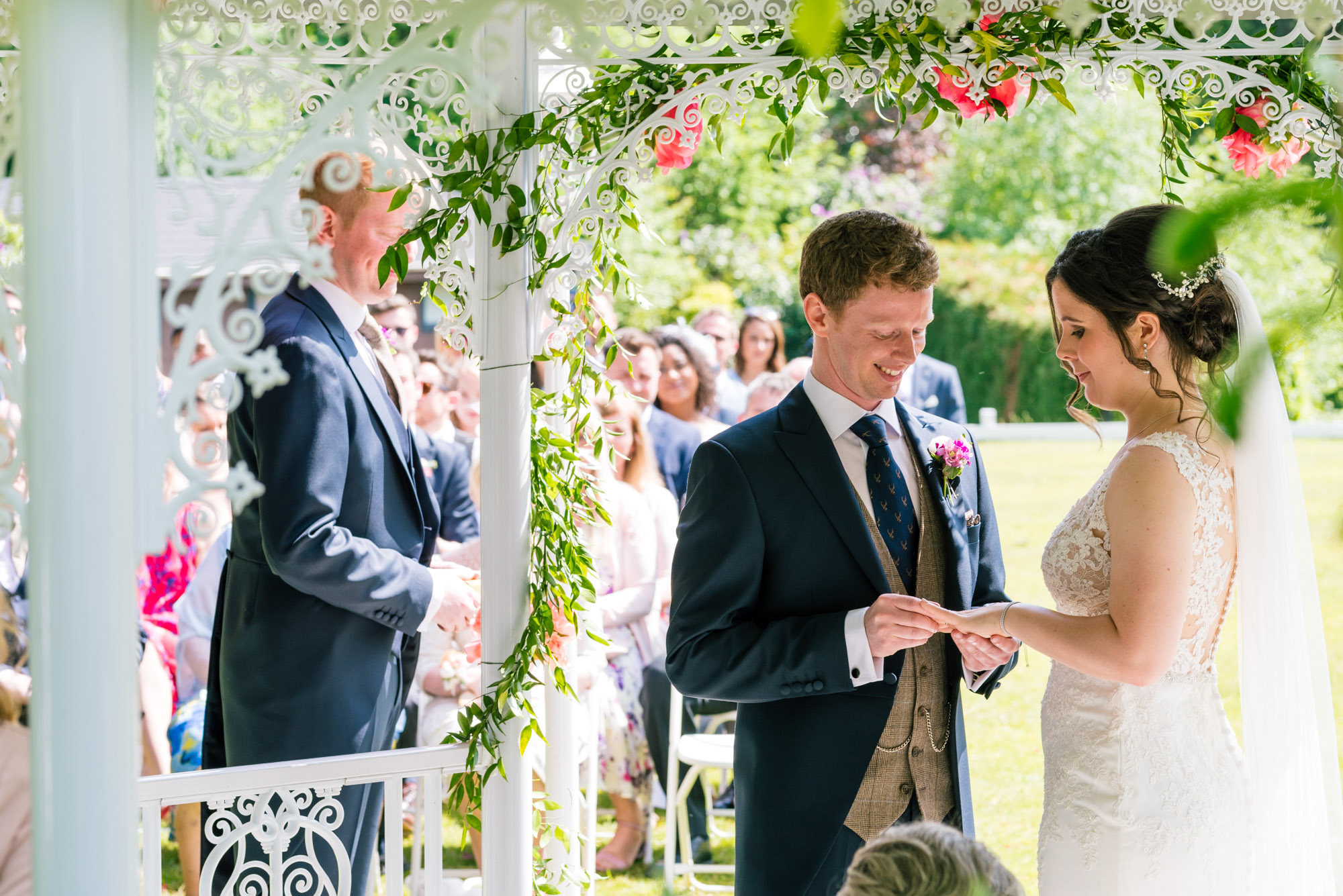 Groom puts the ring on his new wife