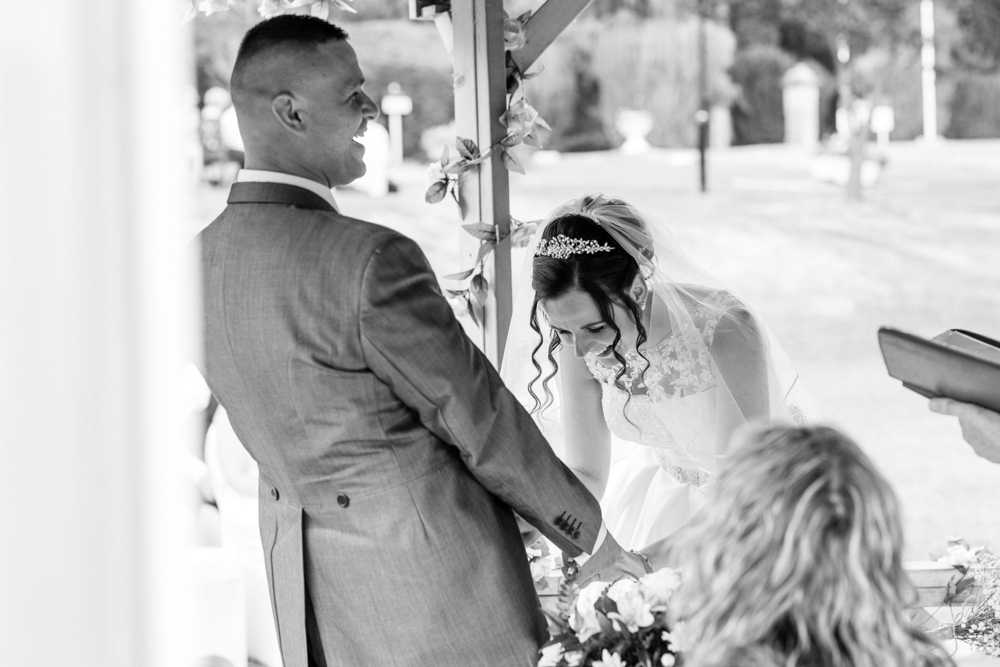 Bride and groom laughing during the vows