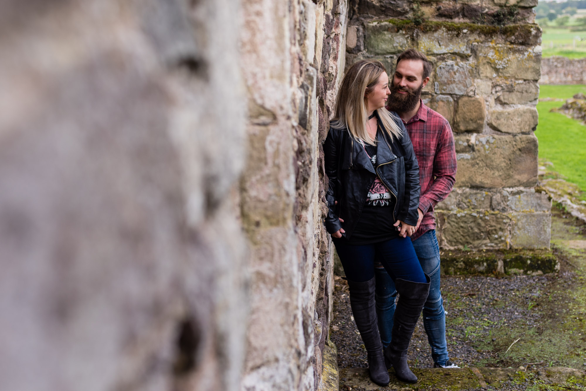 Against the wall looking at each other