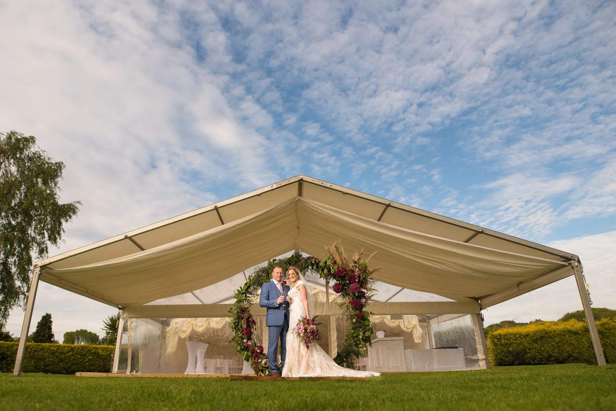 Bride and groom in front of the marquee