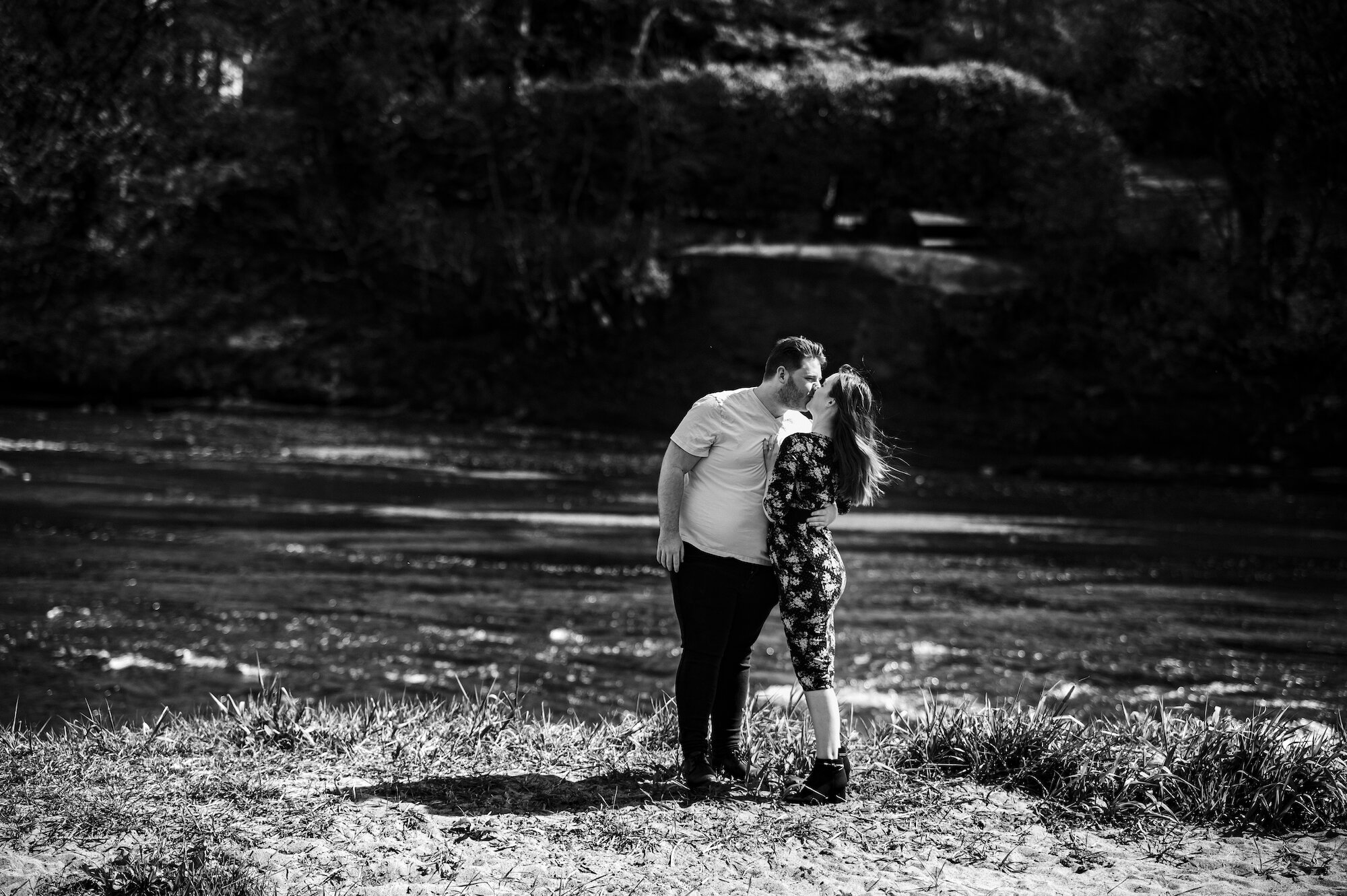 Couple kissing by the river