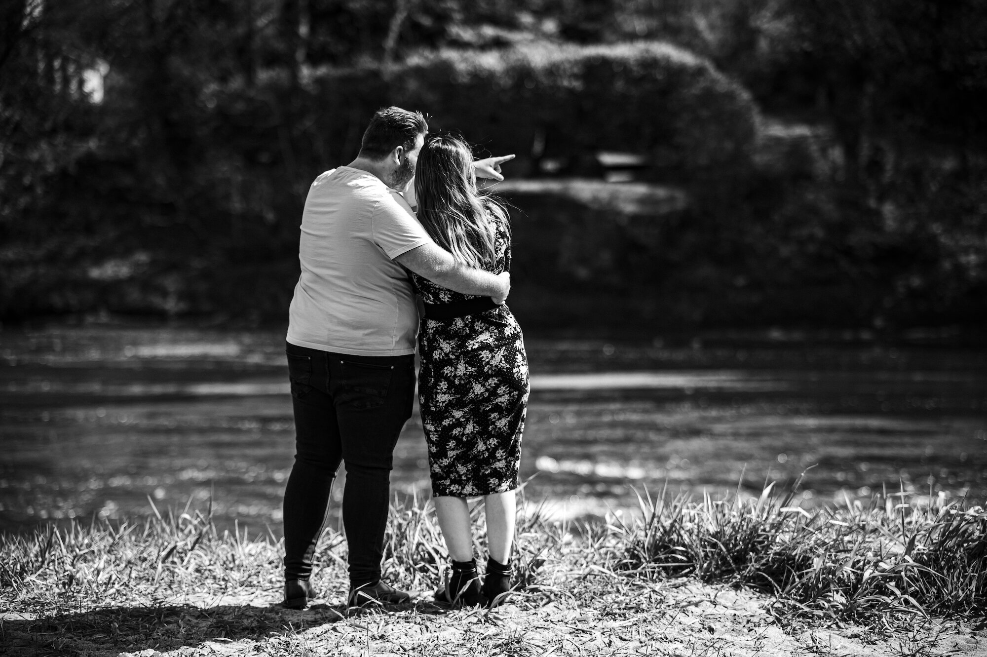 Couple looking away from the camera by the river