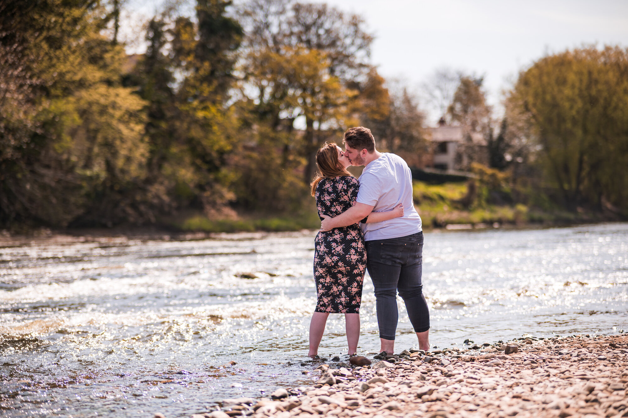 Couple kissing, standing in the river