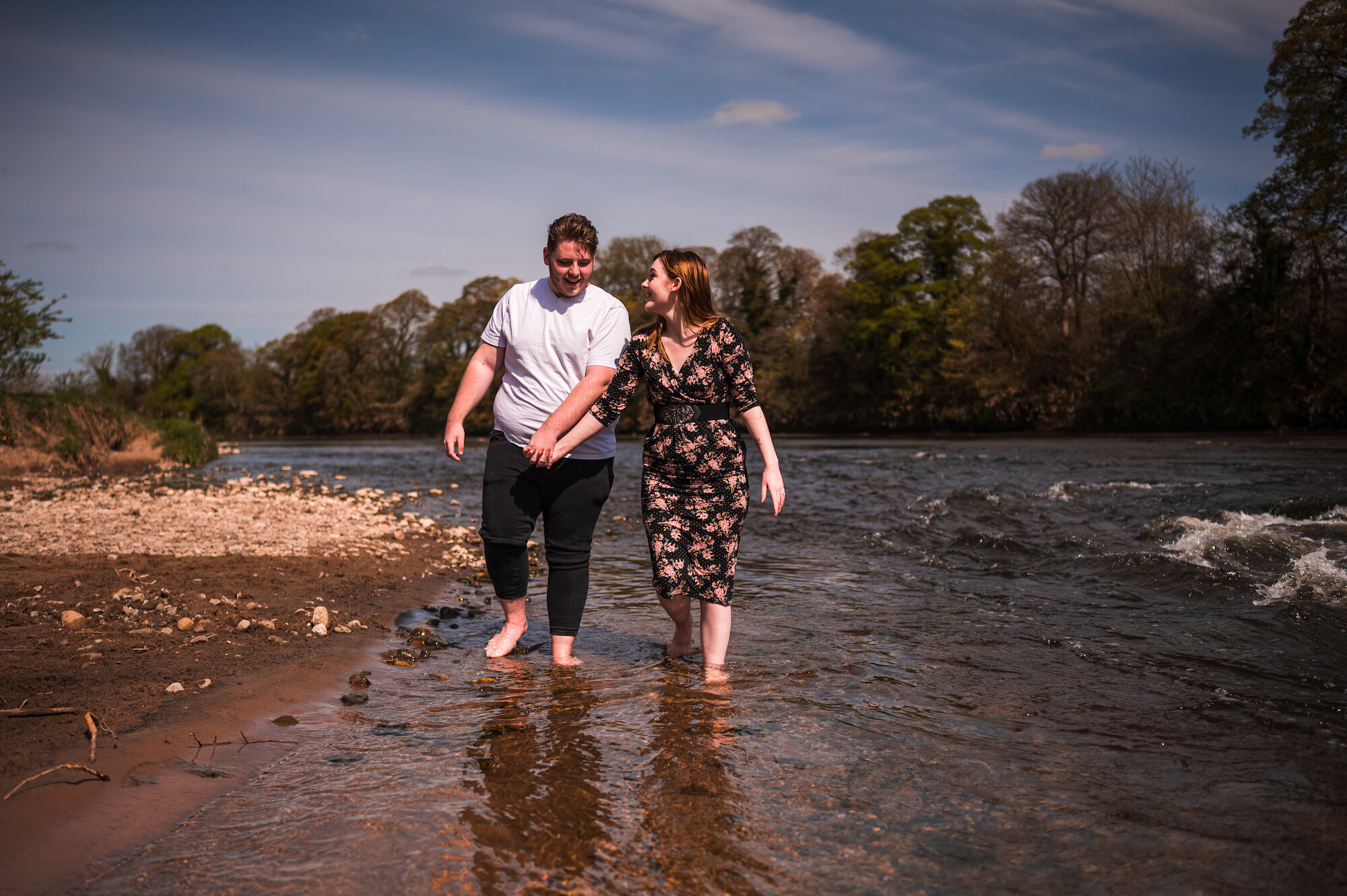 Ellisse and James walking in the river shallows