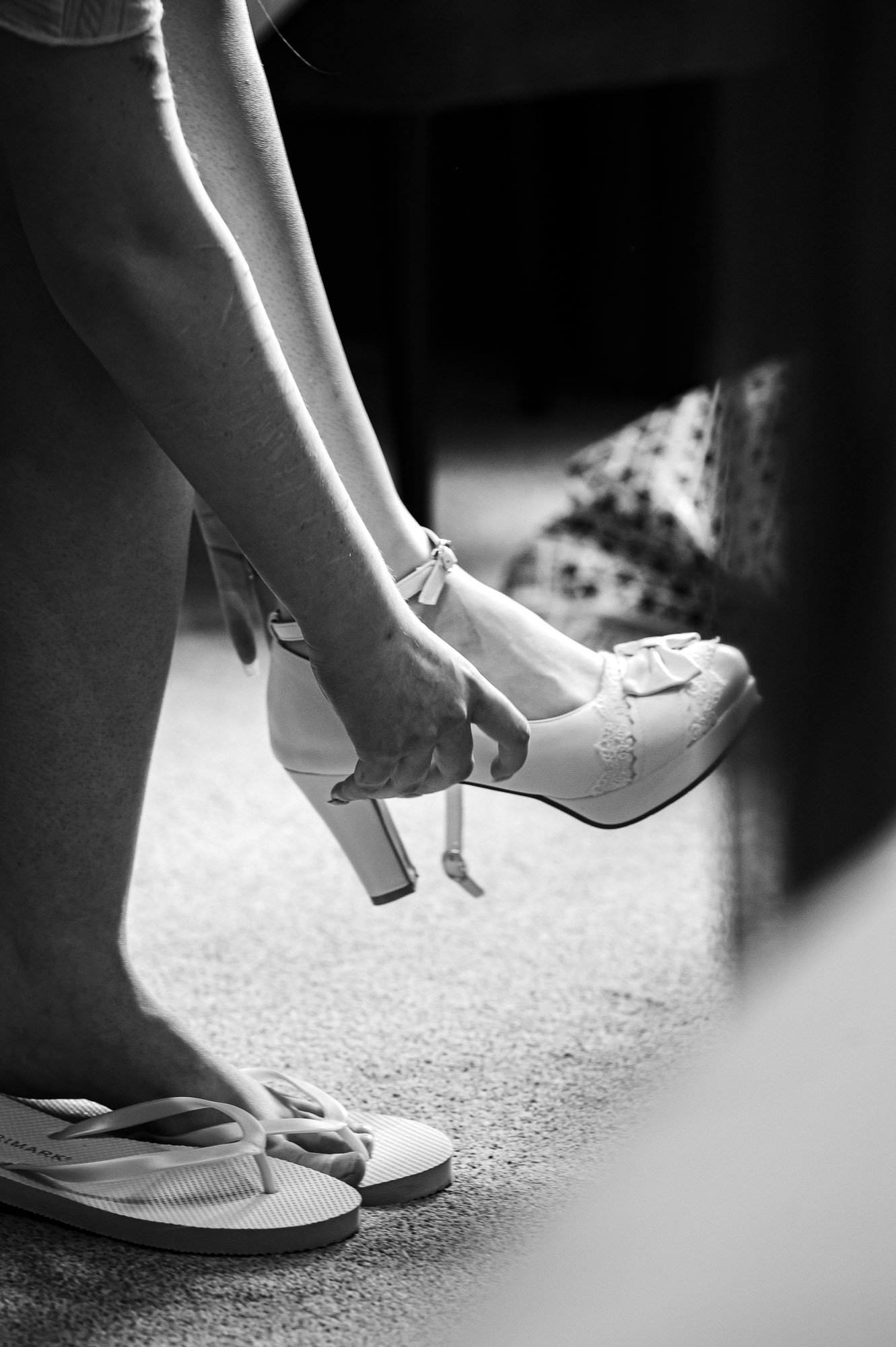 Bride putting on her wedding shoes