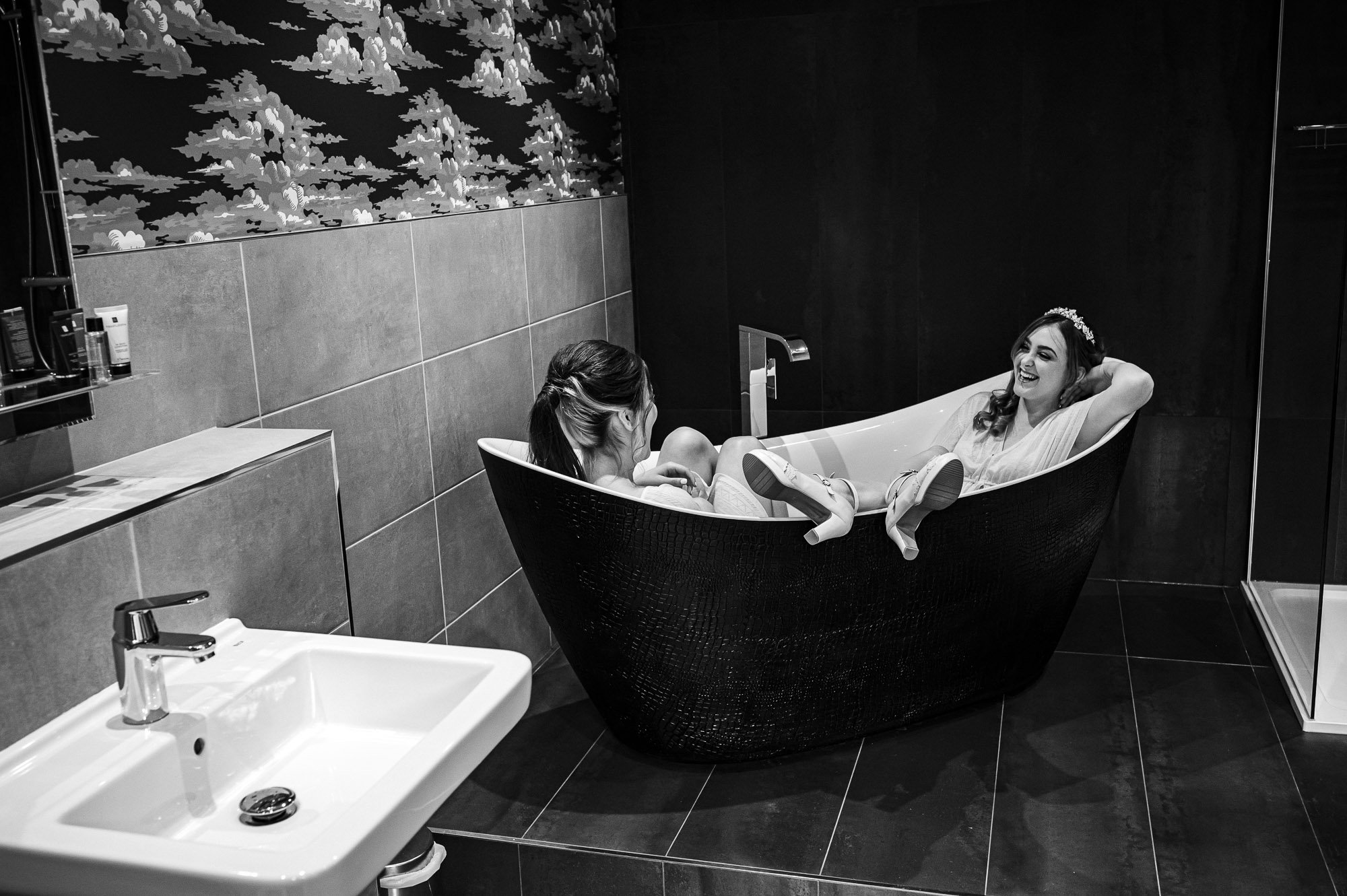 Bride and bridesmaid laughing in the bath!