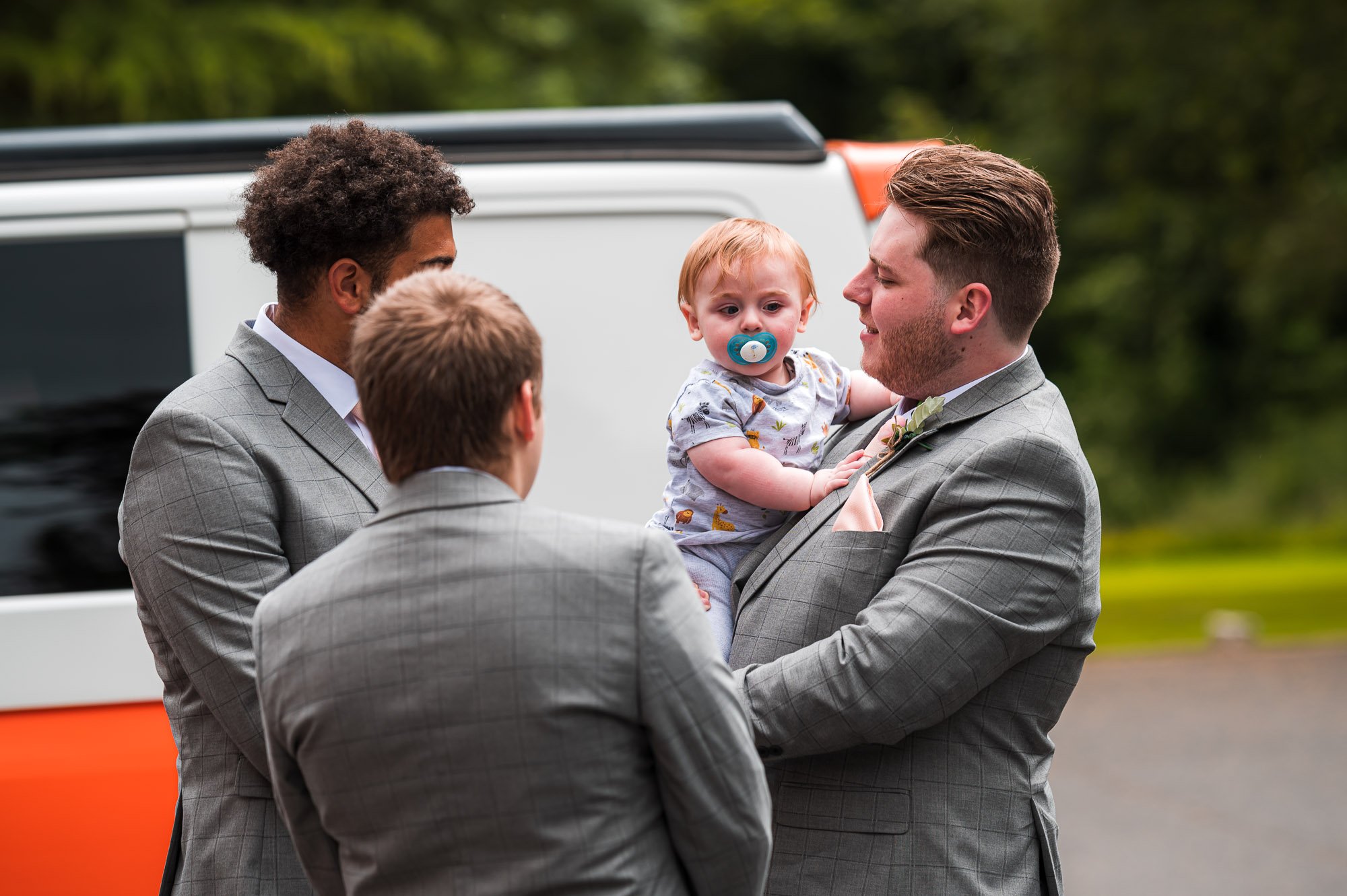 Groomsmen with the groom's baby son