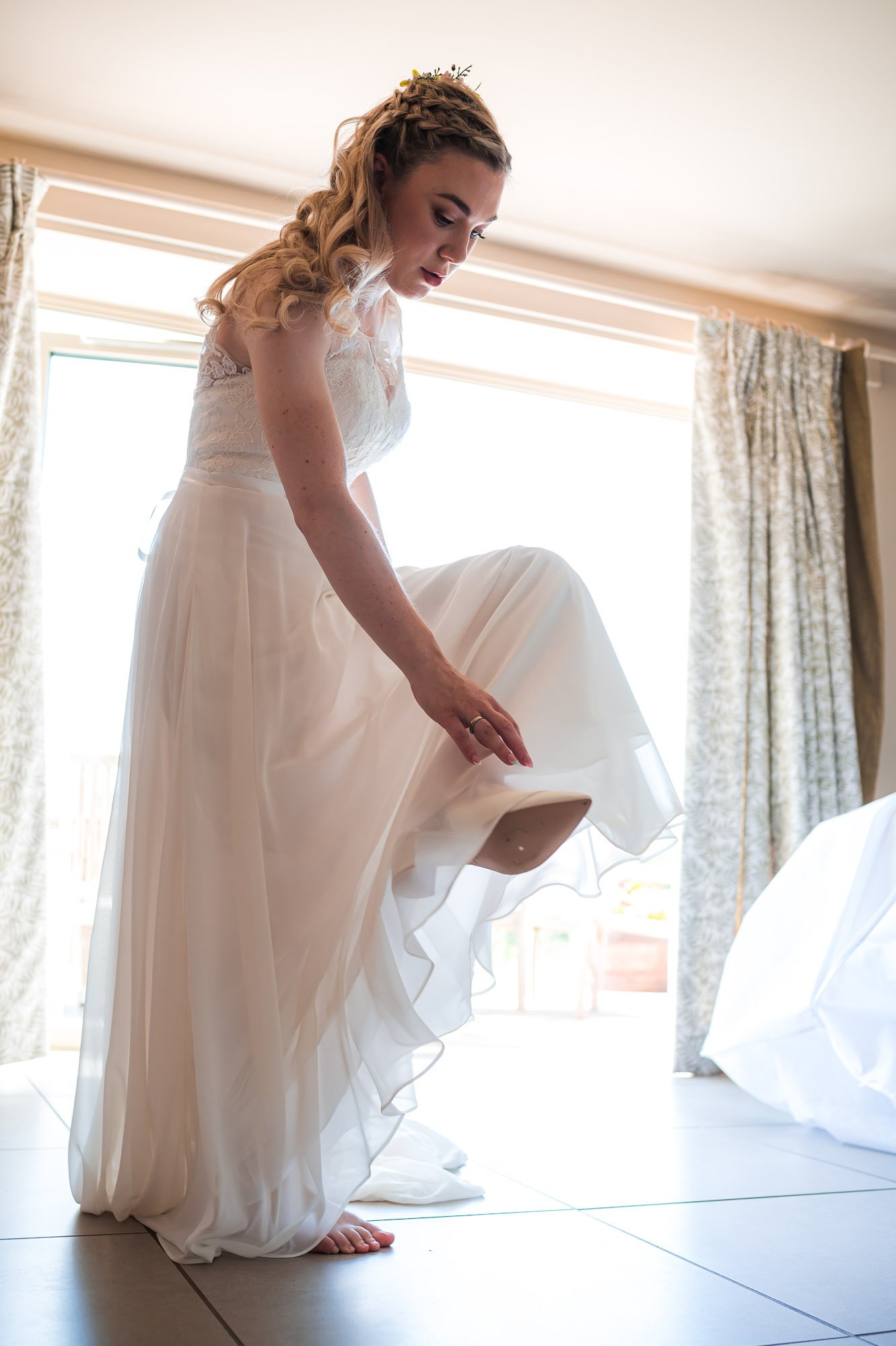 Bride putting her shoe on