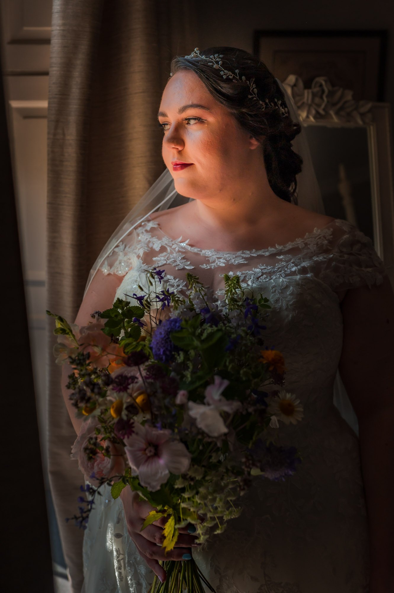 Megan, the bride, looks out of the window