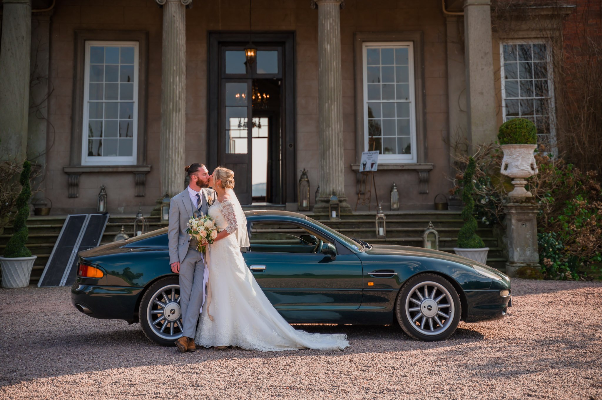 Bride and groom by the car