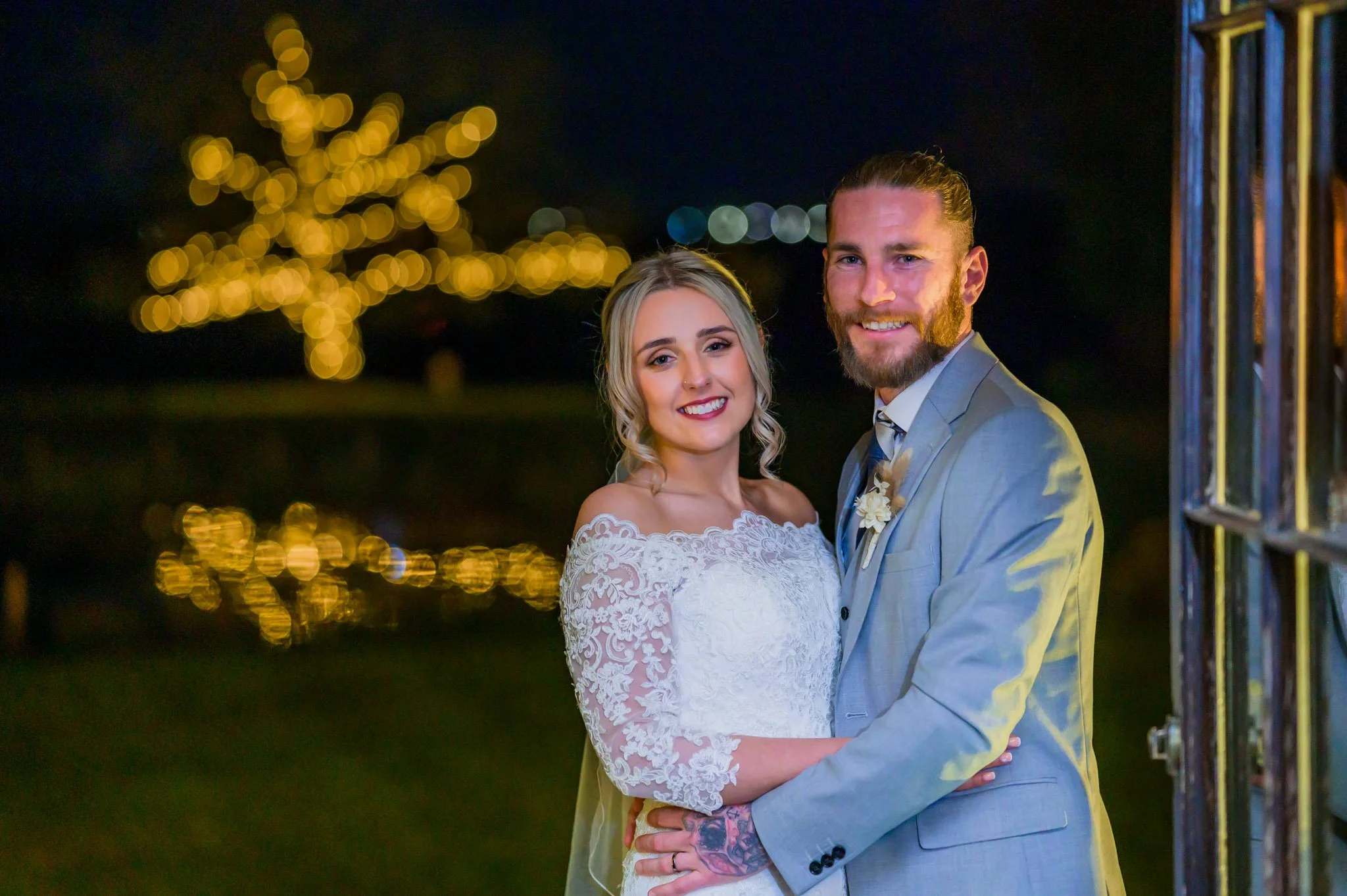 Couple with a lit up tree