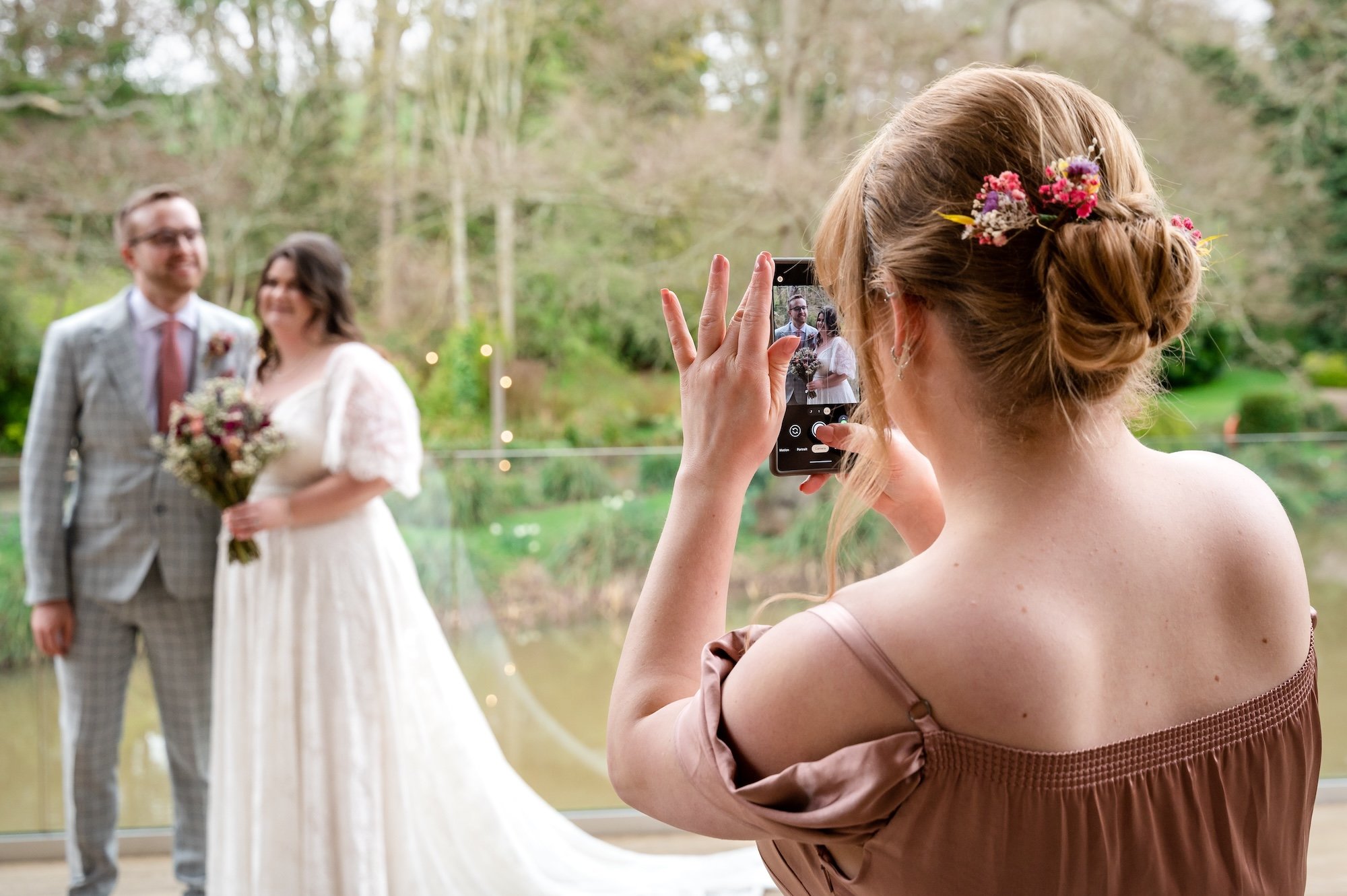 Couple pose for pictures on the decking at The Mill Barns Wedding Venue