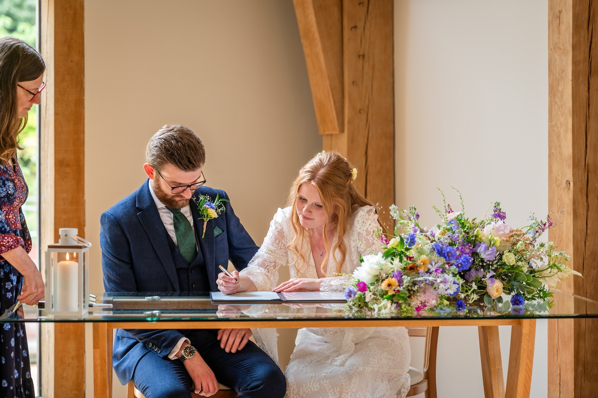 Rhian and Josh signing their register at The Mill Barns Wedding Venue