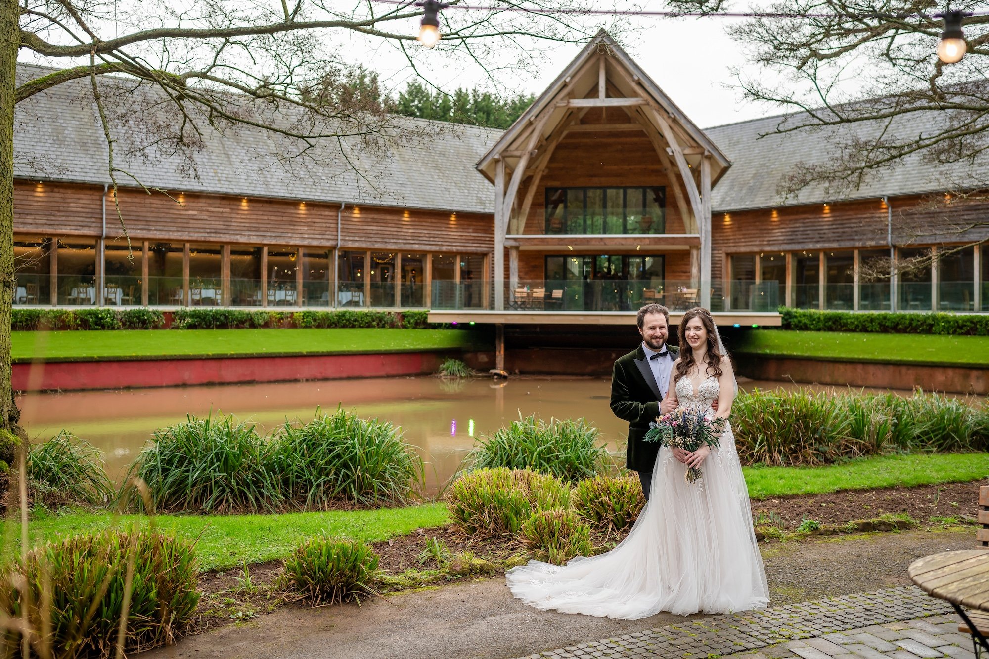 The Mill Barns wedding Venue in the back ground with Jen and Tom