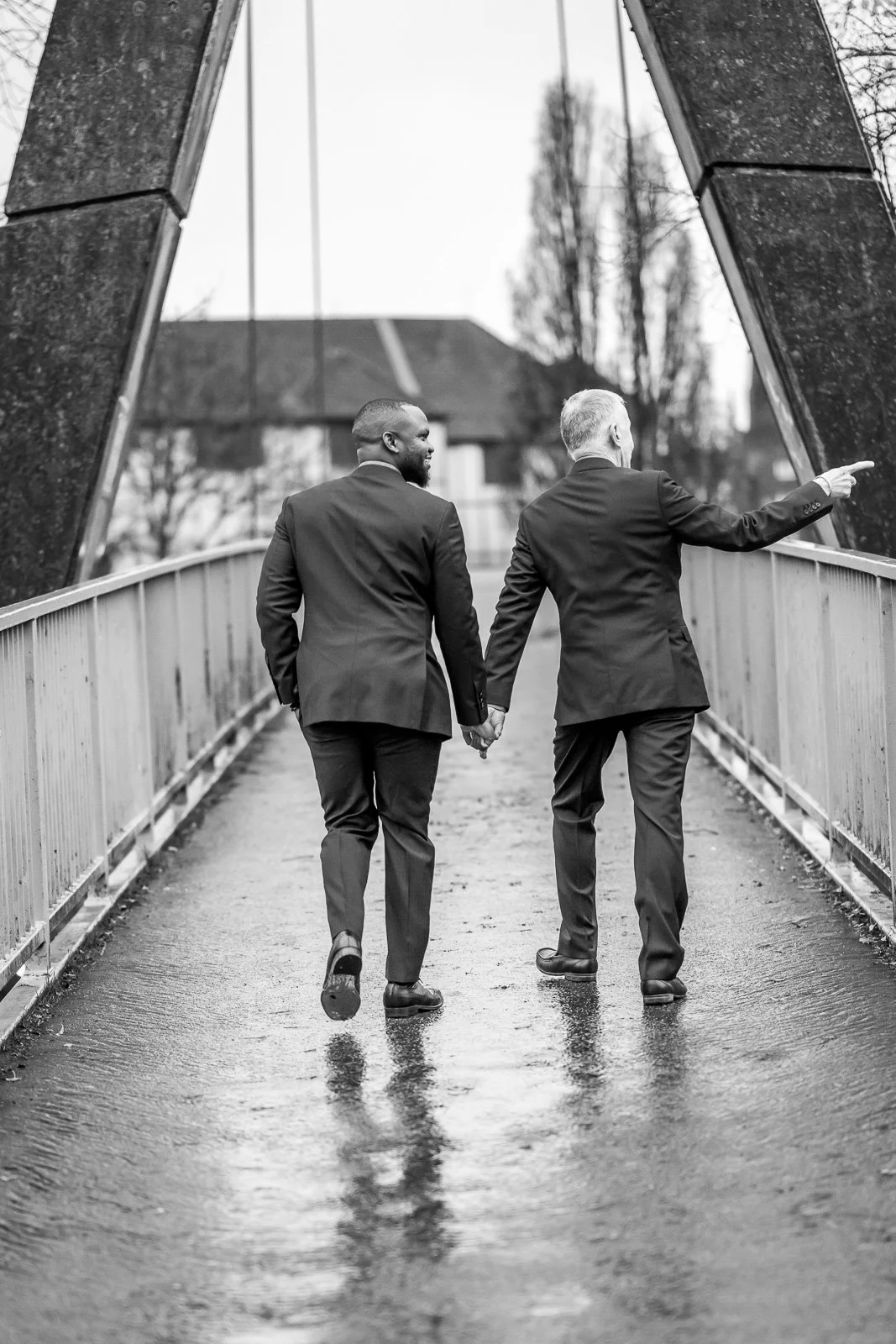 same sex male couple walk away from the camera