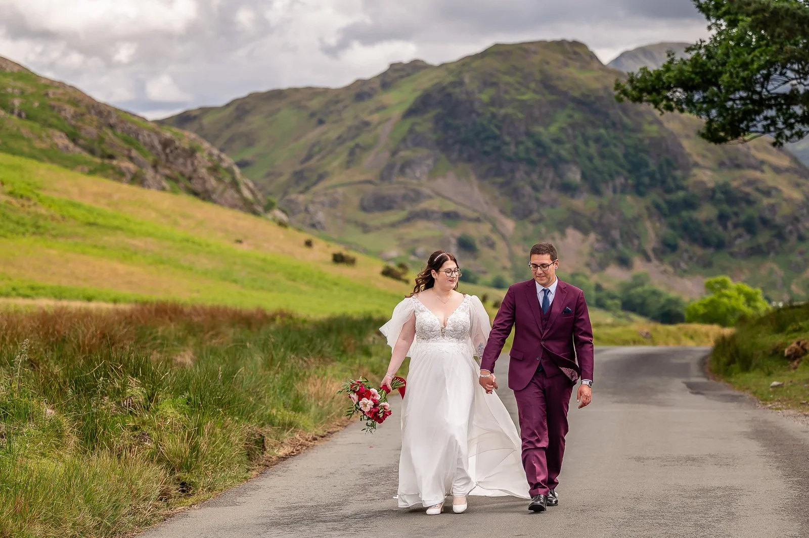 Couple walk on road in the lake district