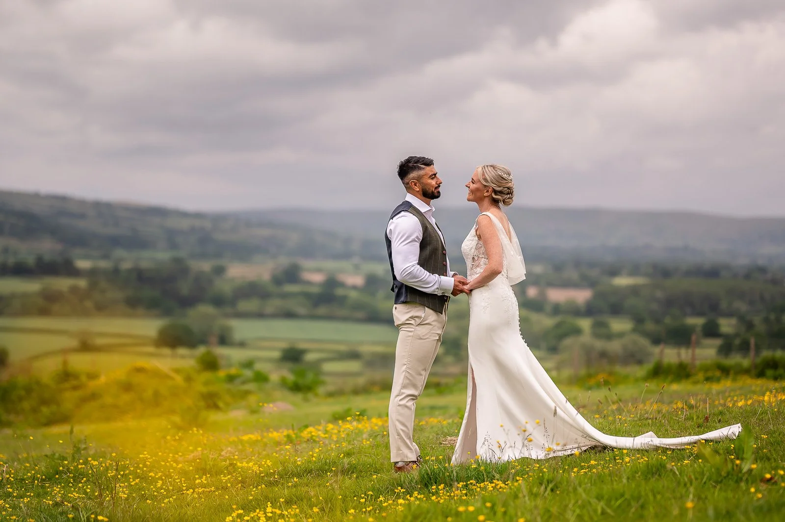 bride and groom with hills in the background