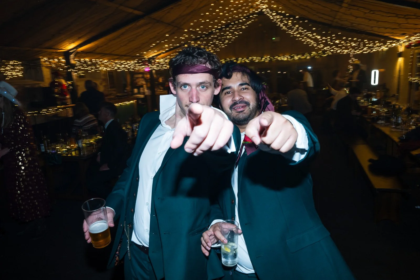 Wedding guests pointing at the camera