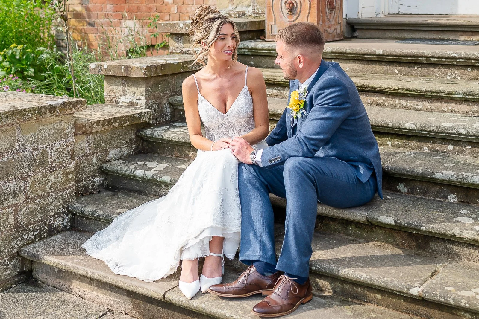 Bride and groom sit on steps