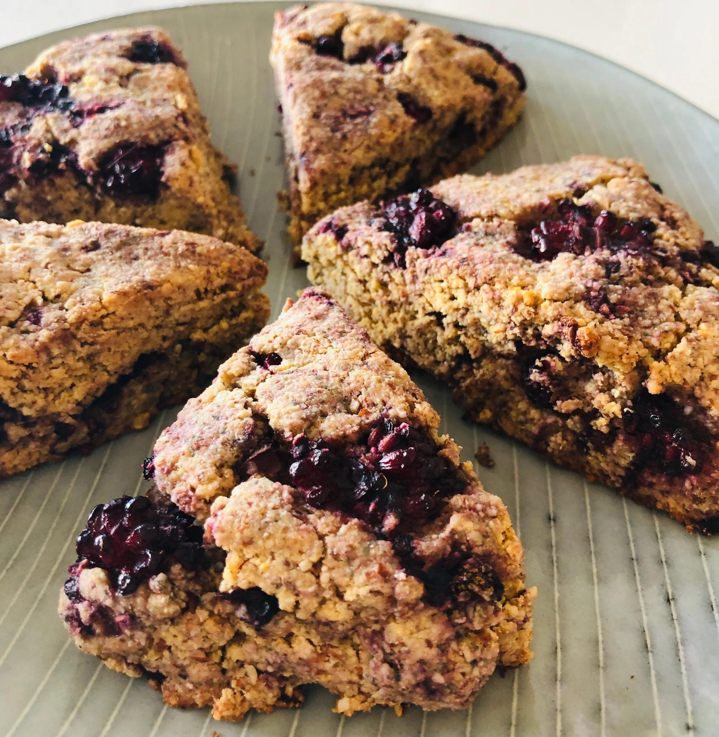 Blackberry Lemon Scones Dry Ingredients: 1 1/2 cups almond flour 1/2 cup cassava flour 1/3 cup coconut sugar 1/4 cup coconut flour 1 tbsp Baking Powder 1/4 tsp salt Wet Ingredients: 1/2 tsp vanilla extract 2 eggs 1 tsp lemon zest 5 tbsp butter, softened 3/4 cup blackberries Directions: 1. Preheat the oven to 350°F. 2. Combine all dry ingredients in a large bowl. 3. Mix the wet ingredients (except blackberries) together in a small mixing bowl. 4. Combine the wet and dry ingredients in the large bowl and add blackberries. 5. Form dough into a one inch thick disk, and cut into 6 equal pieces. You may need to use your hands to form the disk. 6. Place the scones on a baking sheet (preferably parchment lined). Bake for 18-20 minutes, or until lightly browned on the edges.