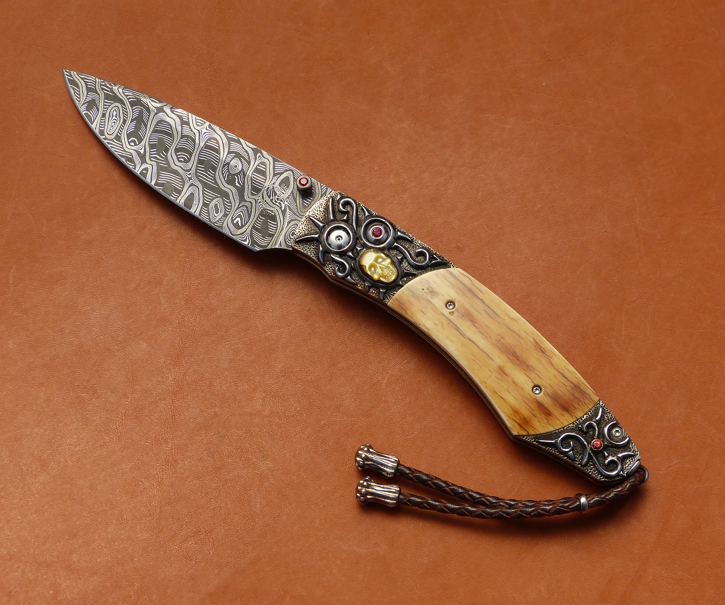 William Henry Damascus button lock. SOLD