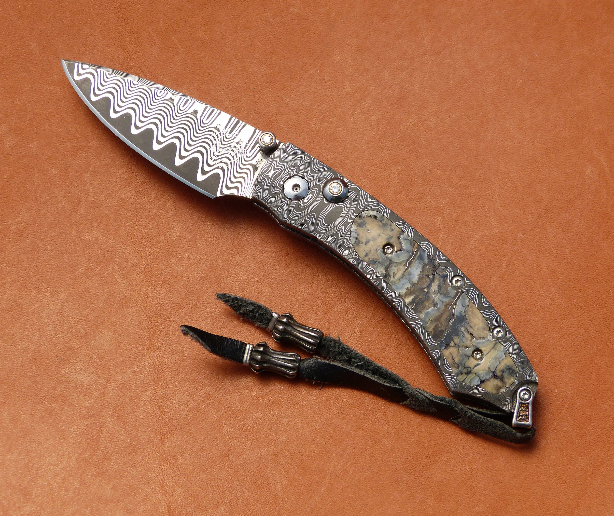 William Henry Damascus button lock. SOLD