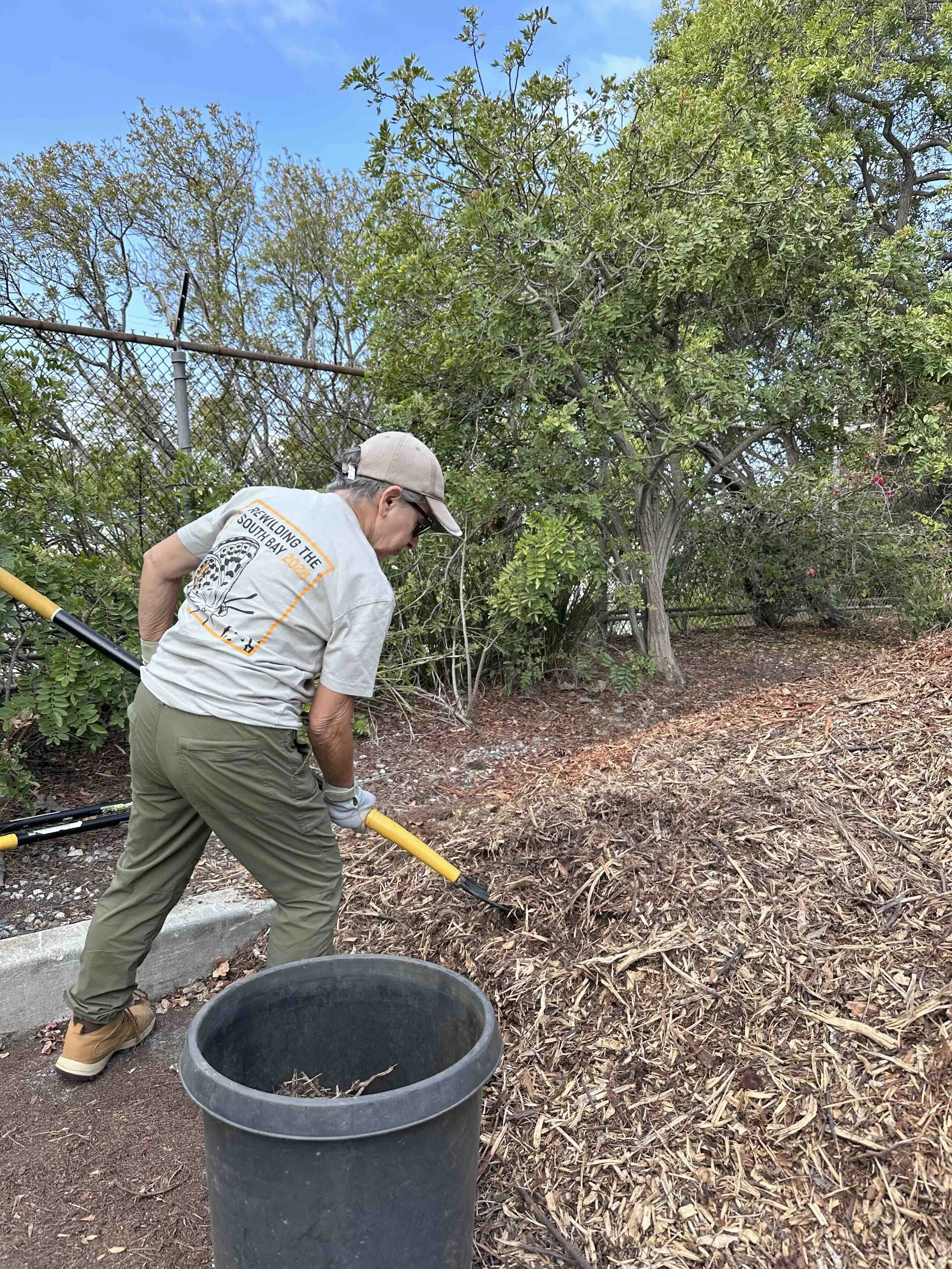 Mitra scooping mulch.jpg