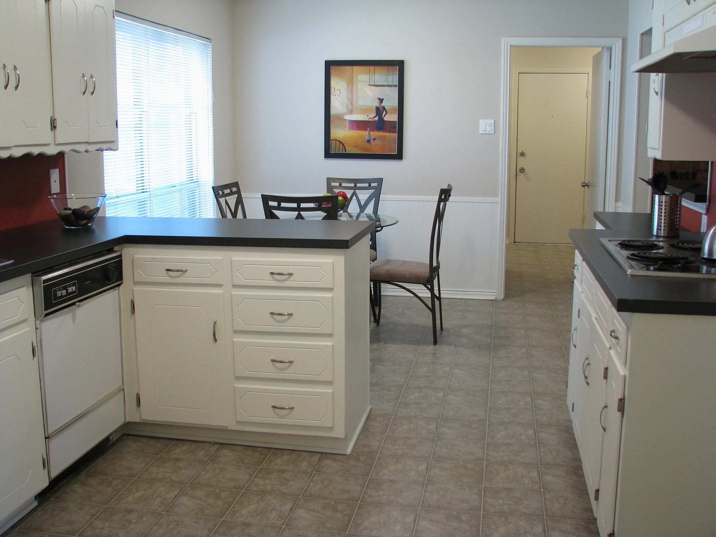 Kitchen after painting the cabinets, new linoleum, new laminant counter tops and staging