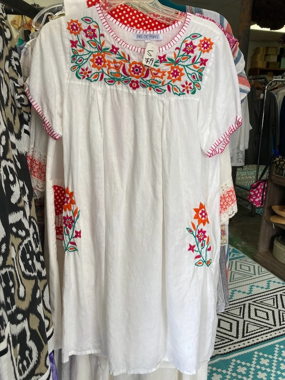 Let's get up close and personal with one of these lovely dresses. Cool, white linen with colorful hand-stitched embroidery with a touch of gold thread. And it has pockets! By Pink City Prints, made in India. Size small $19. Only at GinaWare!