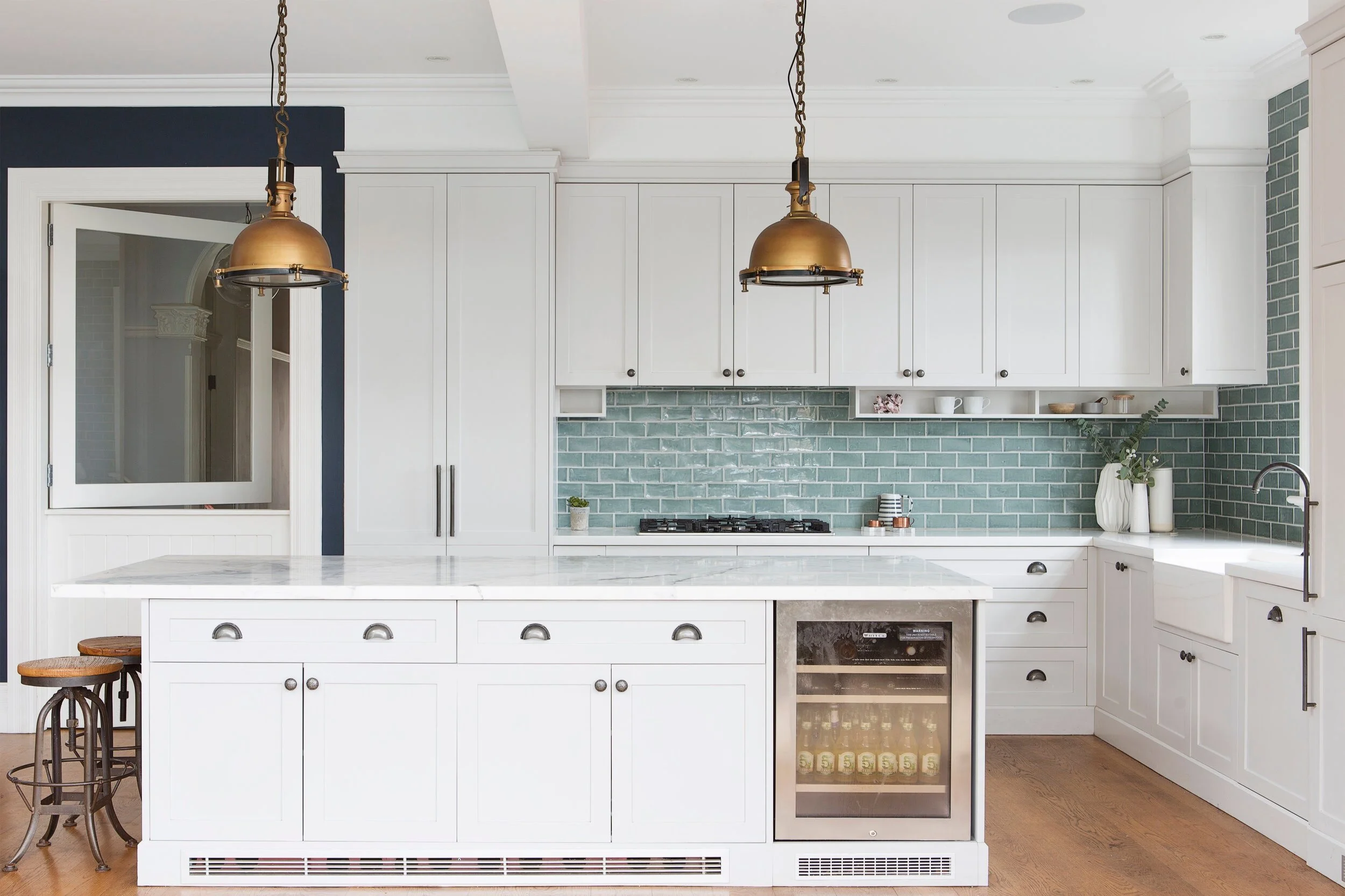 Heritage home kitchen renovation, white kitchen, brass hardware, blue tiles, kitchen island, kitchen bar fridge,natural materials and custom  joinery