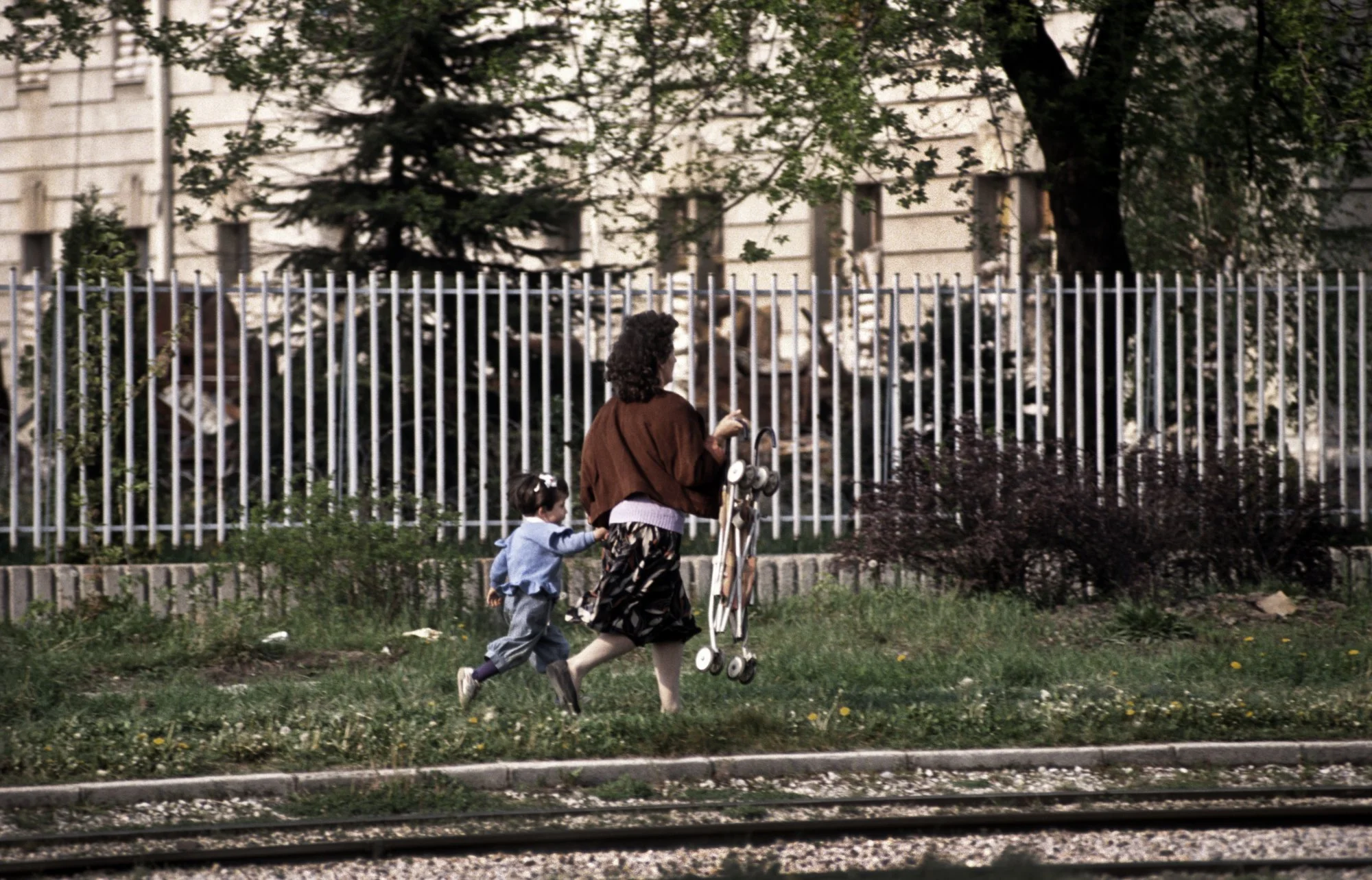 "Sniper Alley" A mother and child run for their lives to avoid being hit by incoming Serb sniper fire. Sarajevo, 1995