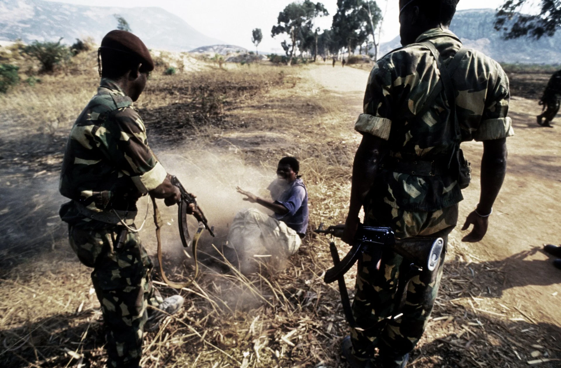 A young man is viciously beaten and then shot (he refused conscription) by MPLA soldiers during Angola's long-running civil war. 1993