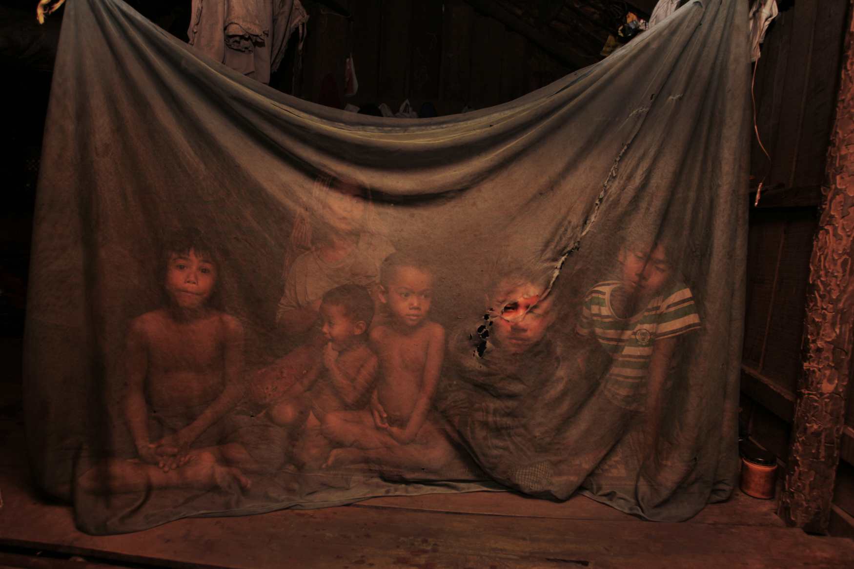  Mother Leng Bo with her family in their hut in the village of Loveathon, Cambodia. 2009 