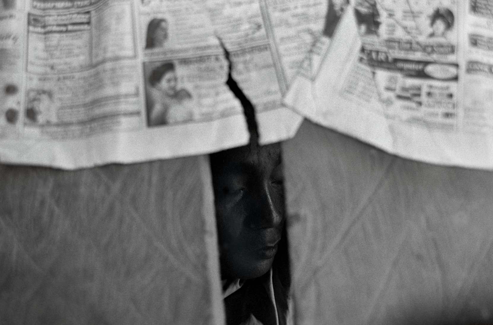  "Under the floorboards" An illegal gold miner sleeps before his next shift.&nbsp;Sulawesi, Indonesia. 2002 