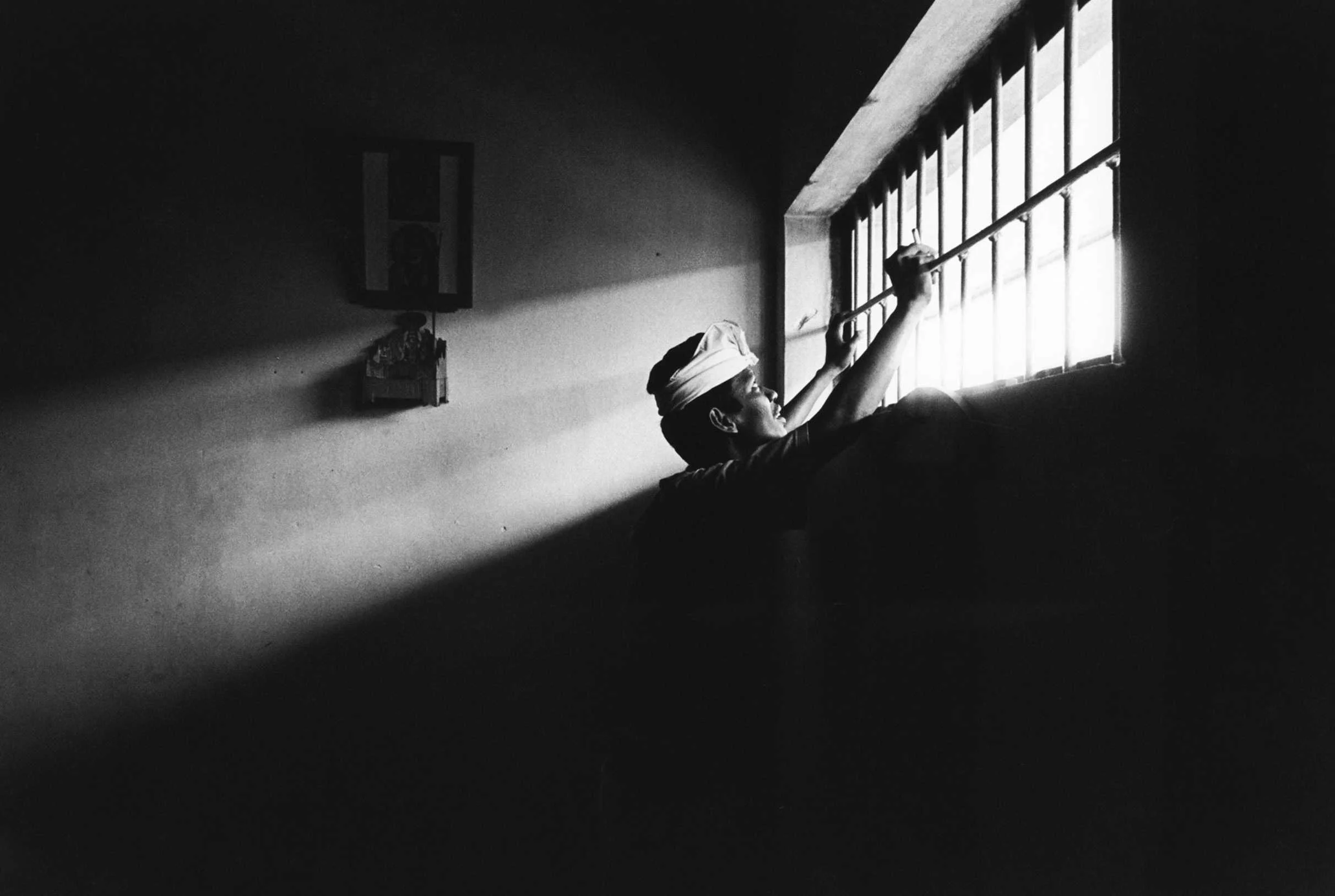 The outside pours in. An inmate at Kerobokan Prison. Bali, Indonesia. 