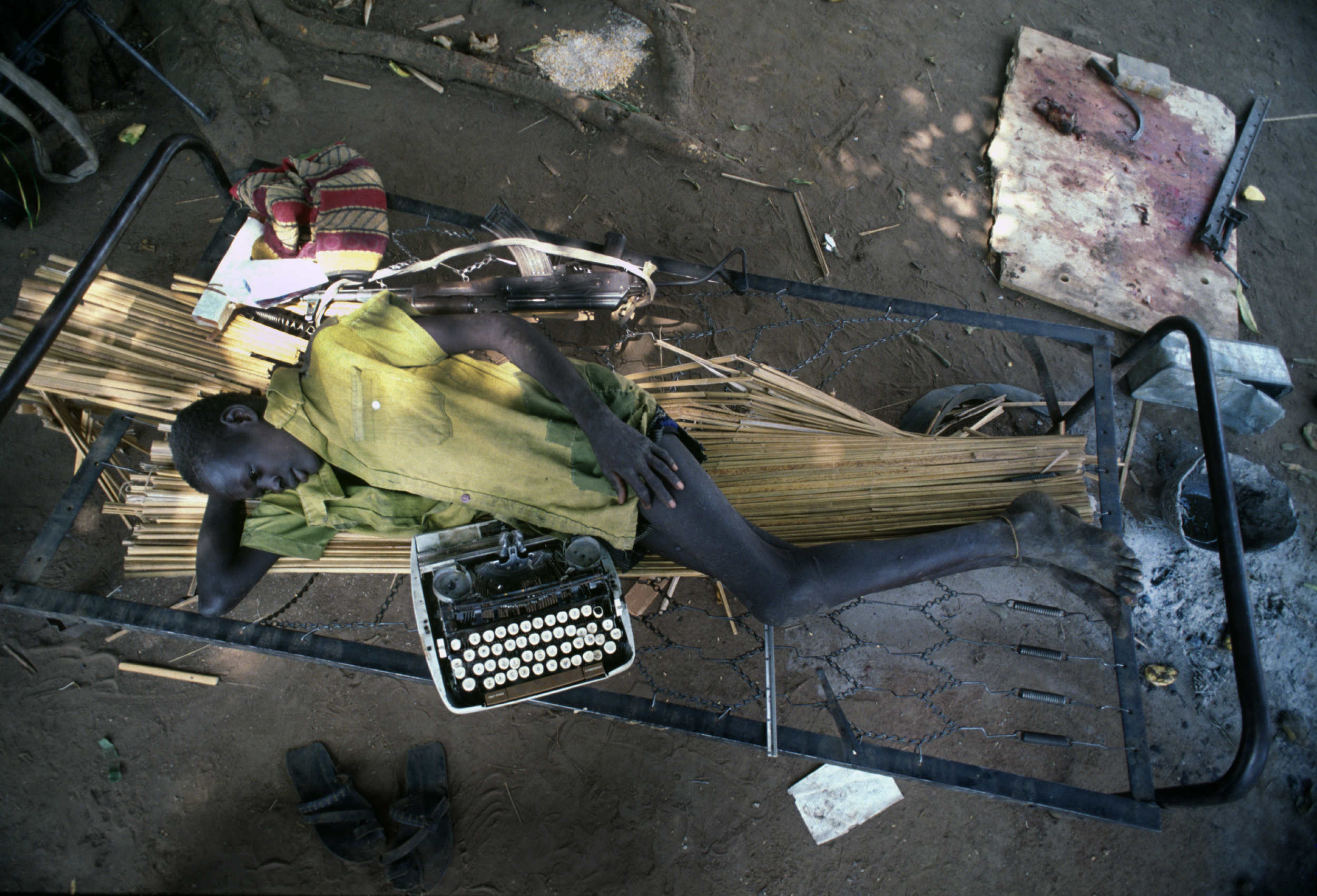  "Typewriter and Gun" A SPLA rebel soldier during downtime. During Sudan's long running civil war. 1993 