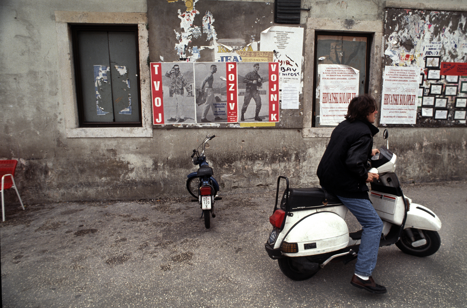  "Irony" The poster on the left shows a civilian to soldier transformation. The small white squares with black borders on the right are 'death notices' for soldiers killed during the war. Dubrovnik, Croatia. 1993 