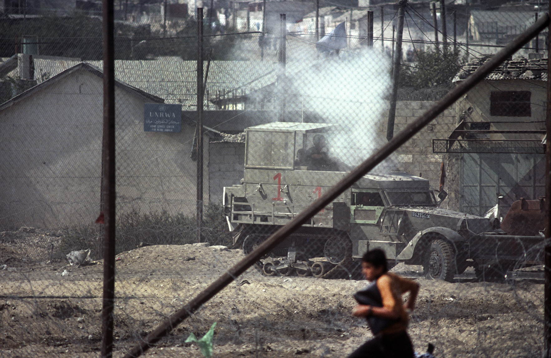  A "Stone Canon' shoots stones at a Palestinian boy.&nbsp;First Intifada. Gaza Strip, 1992 