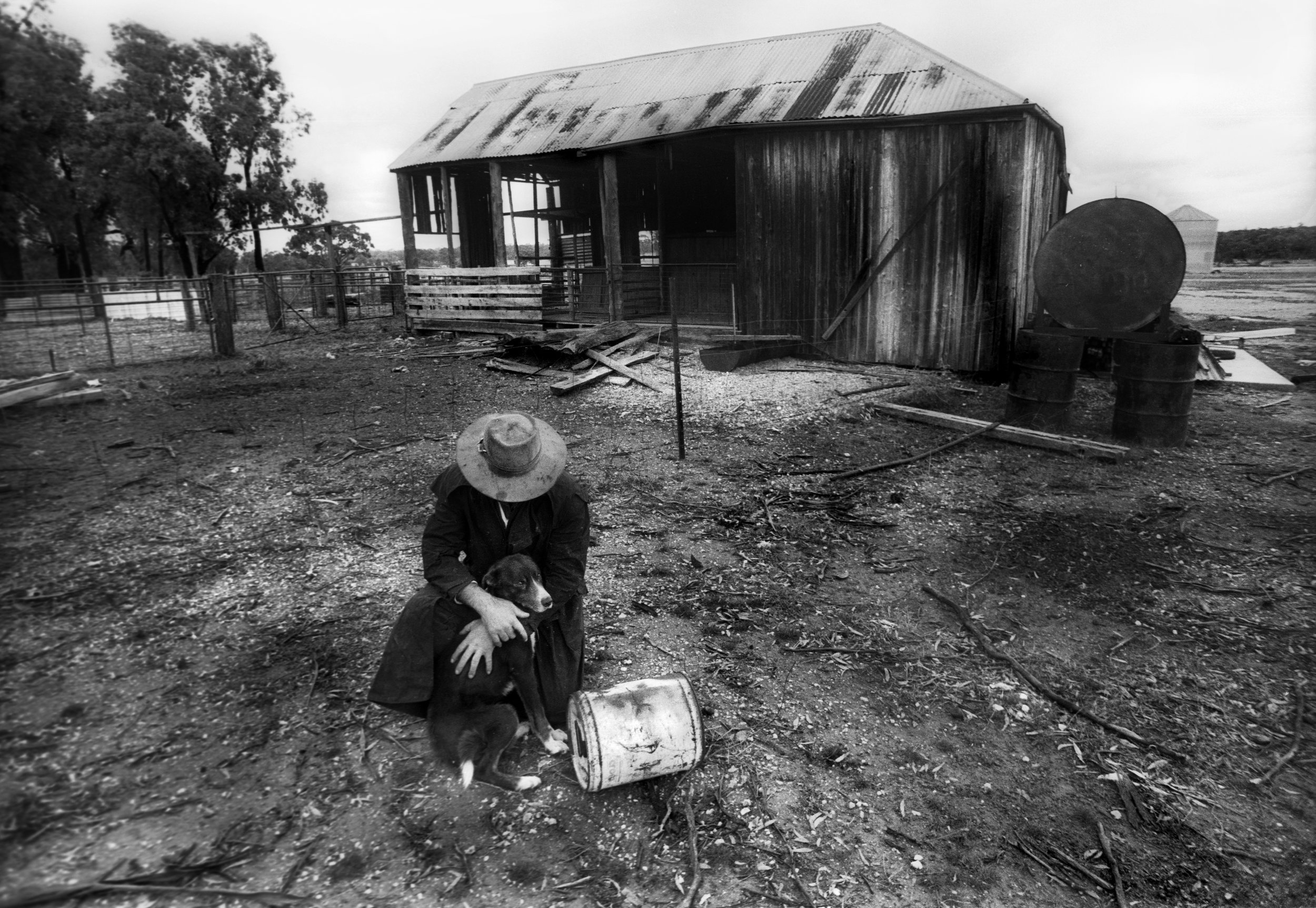  Drought stricken farmer and his dog on a sheep property near Bourke, outback NSW, Australia. 1997 